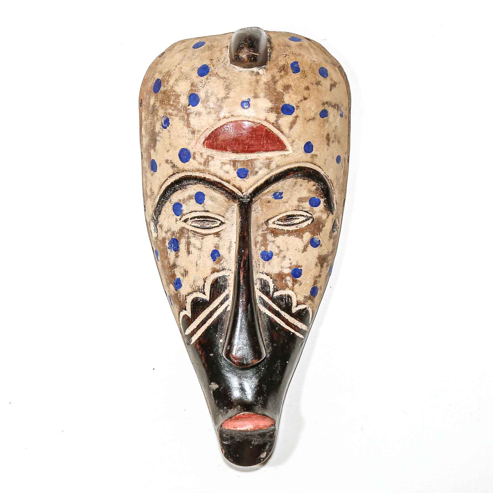 Wooden mask with black, blue, and red details on a white background