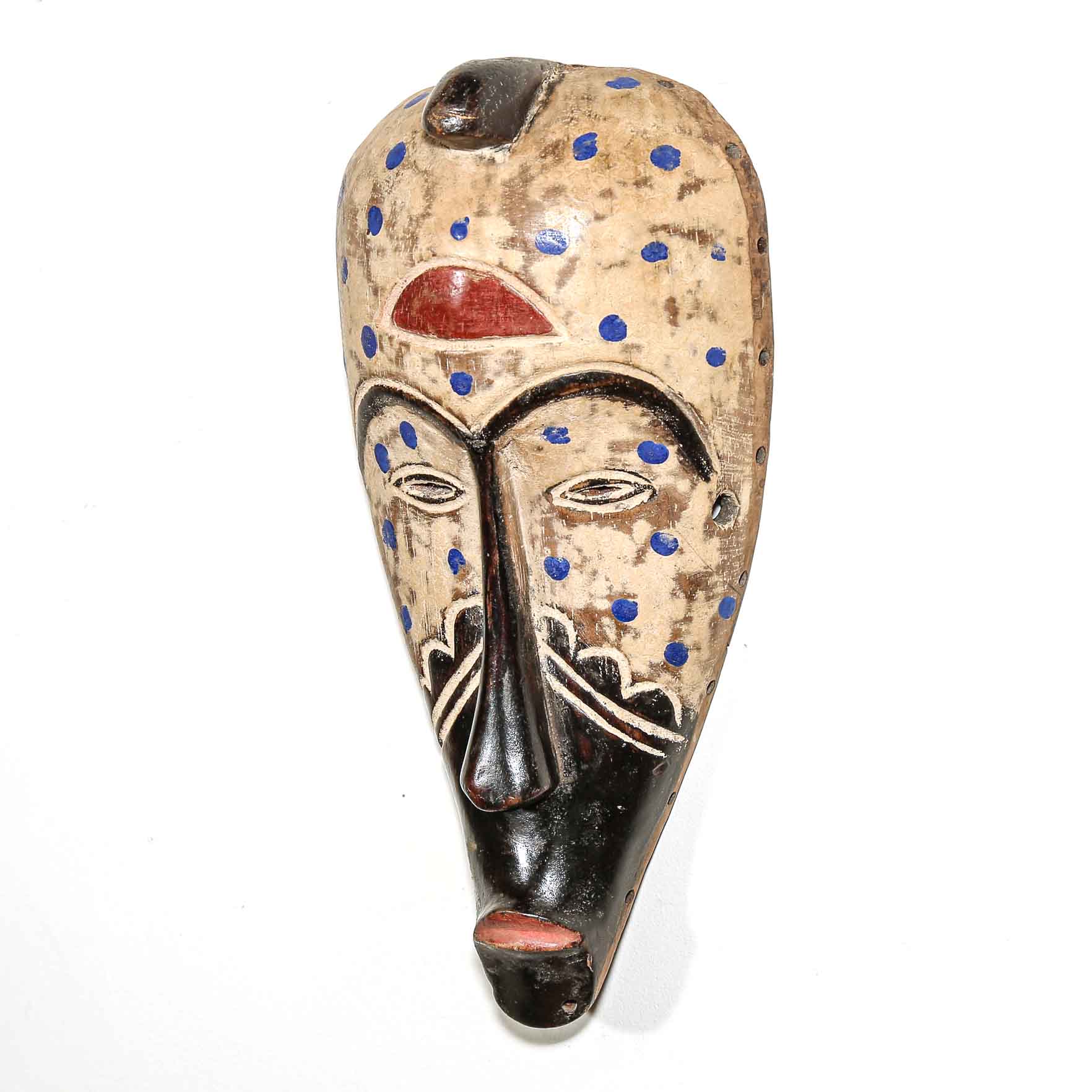 authentic tribal african art mask on a white wall