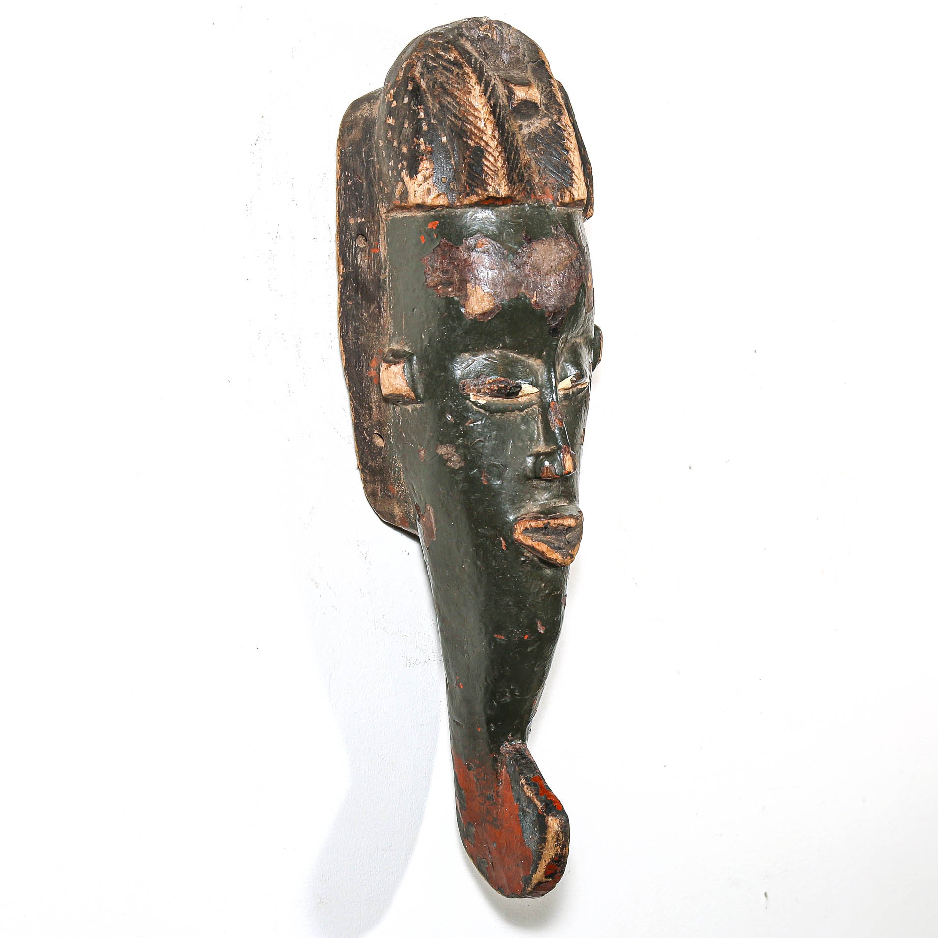 Wooden mask with a face on a white background