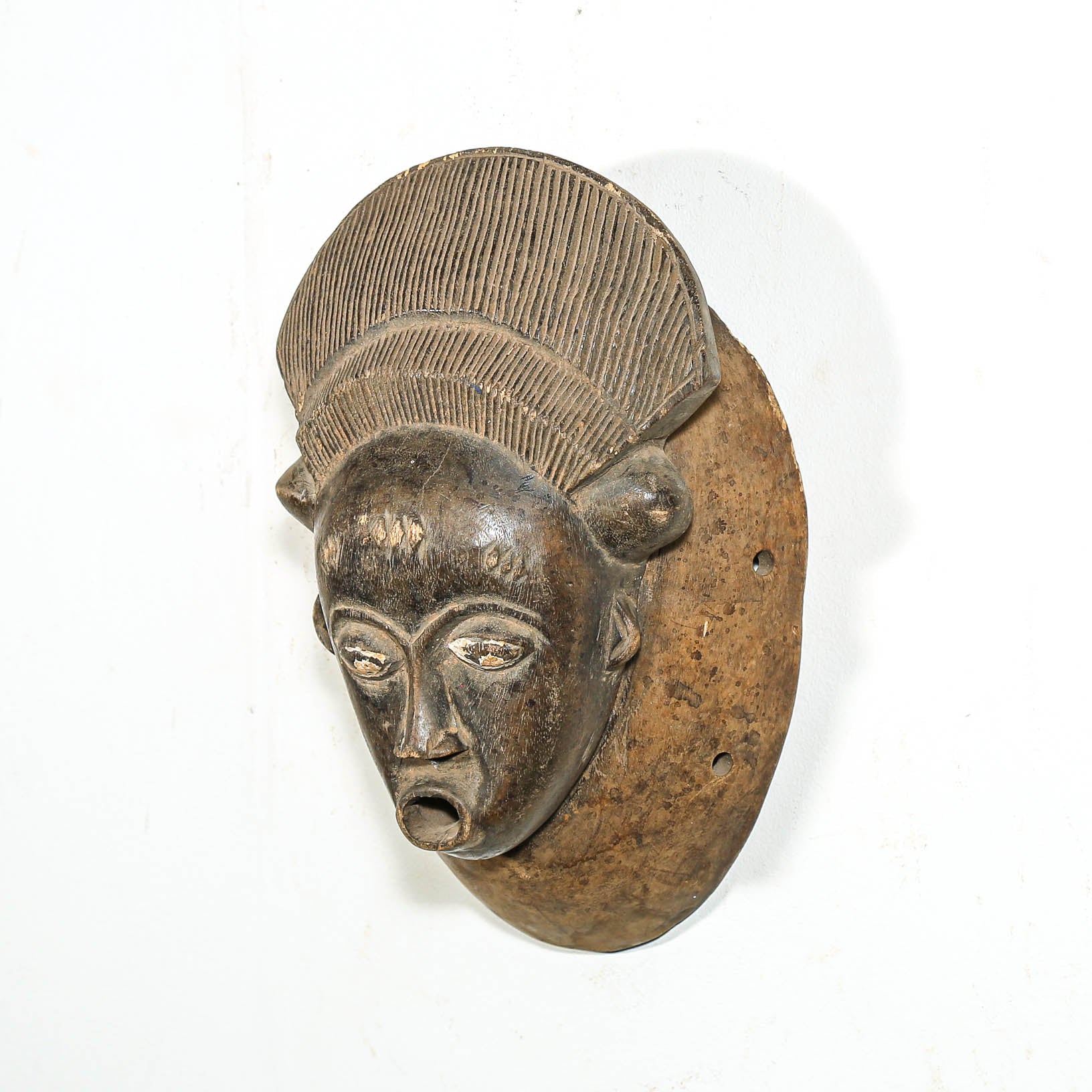 Wood mask with detailed features on a white background