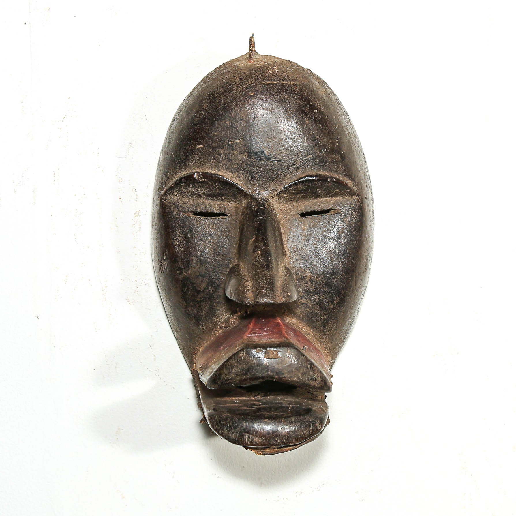 Black African Art tribal art hanging on a white living room wall