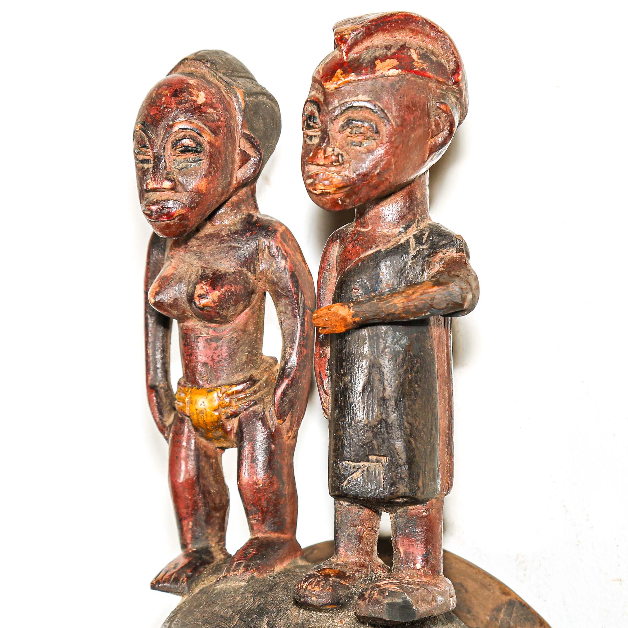 Wooden figurines of a man and a woman on a white background