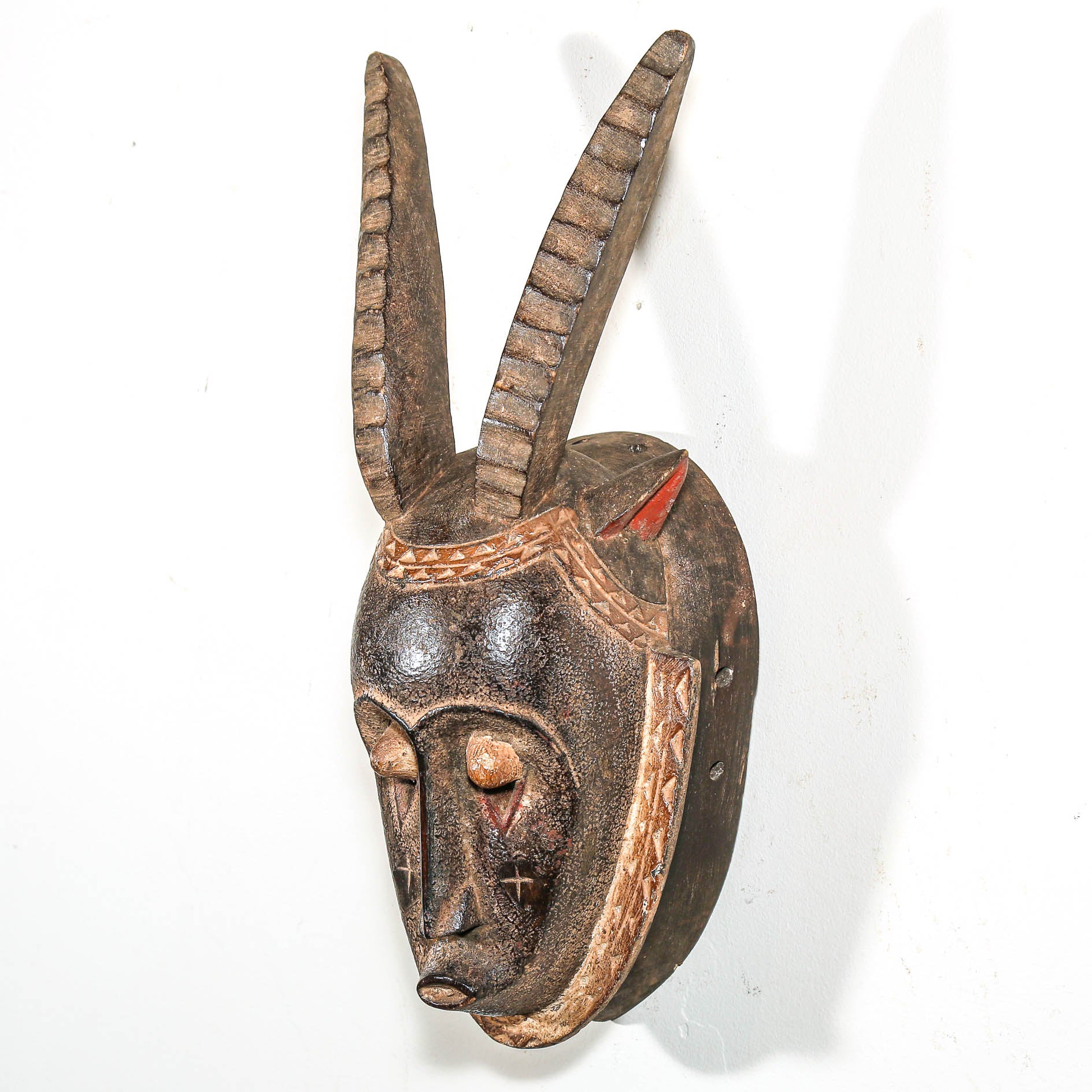ceremonial Wooden mask with long horns on a white background