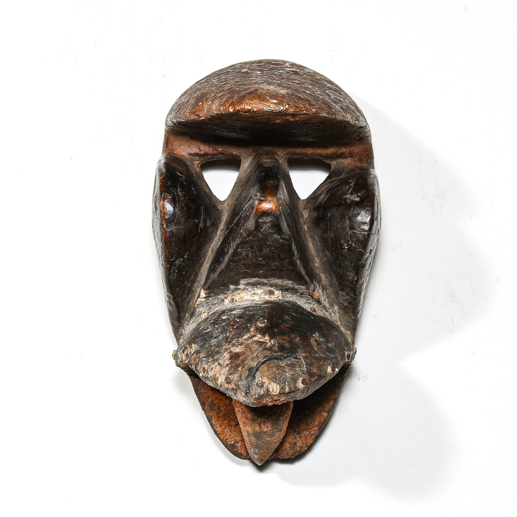 Black African art wood mask with a white collector's wall