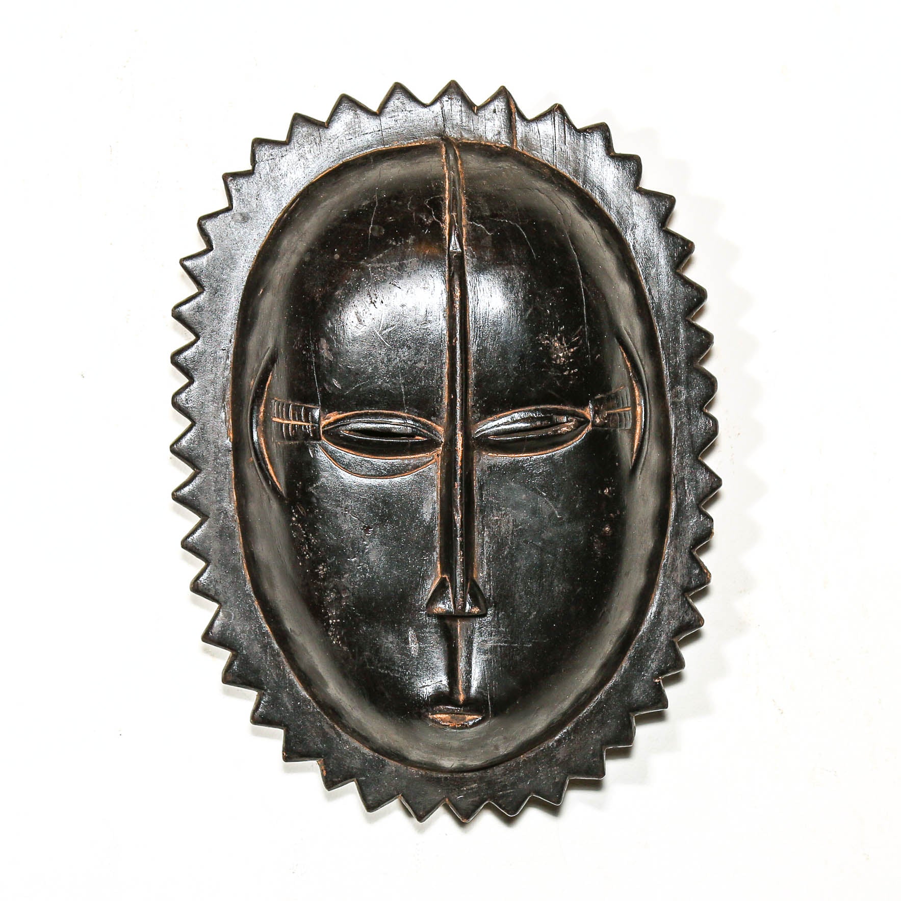 Black African mask with a white background