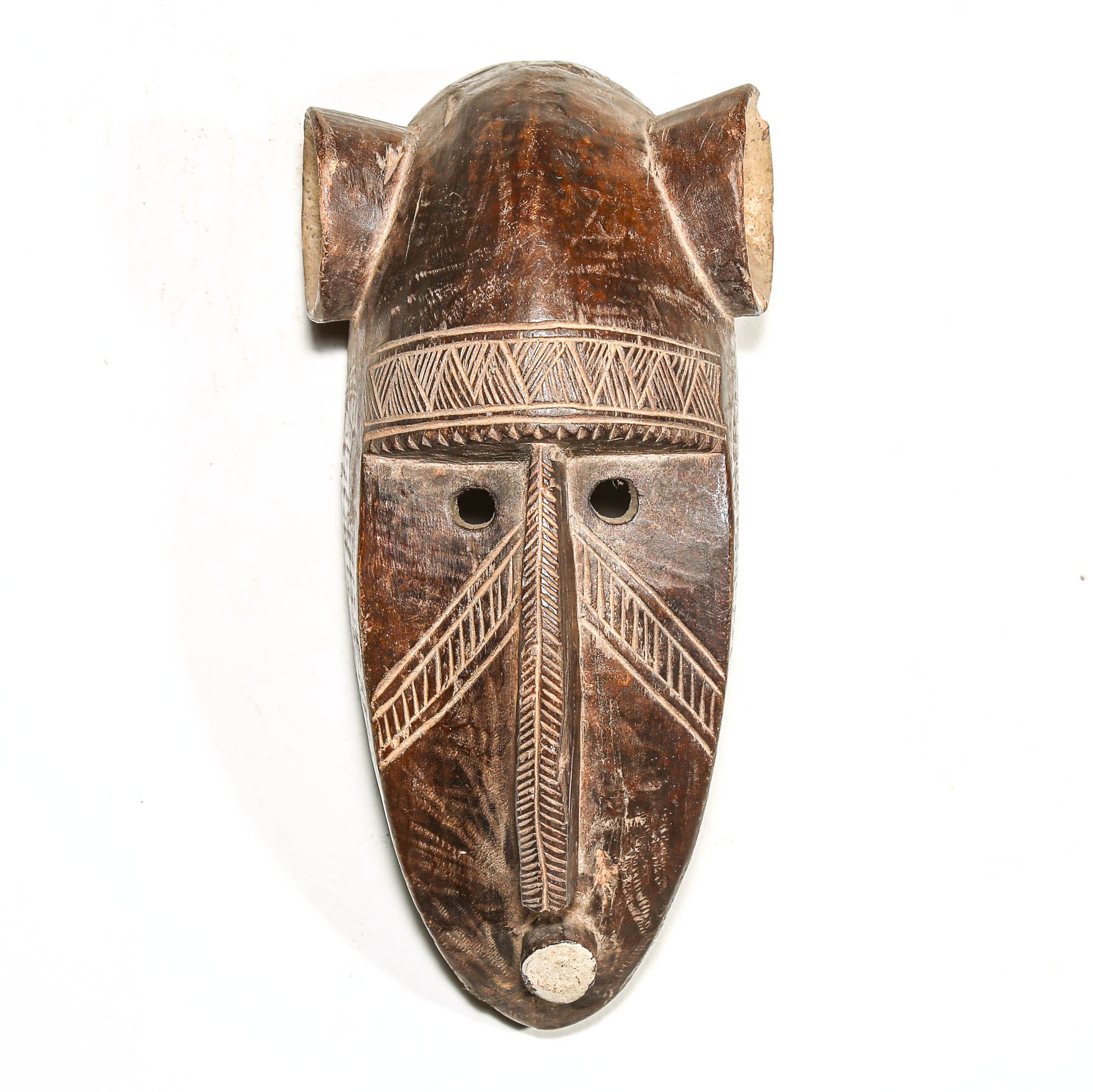 Wooden mask with tribal patterns on a white background