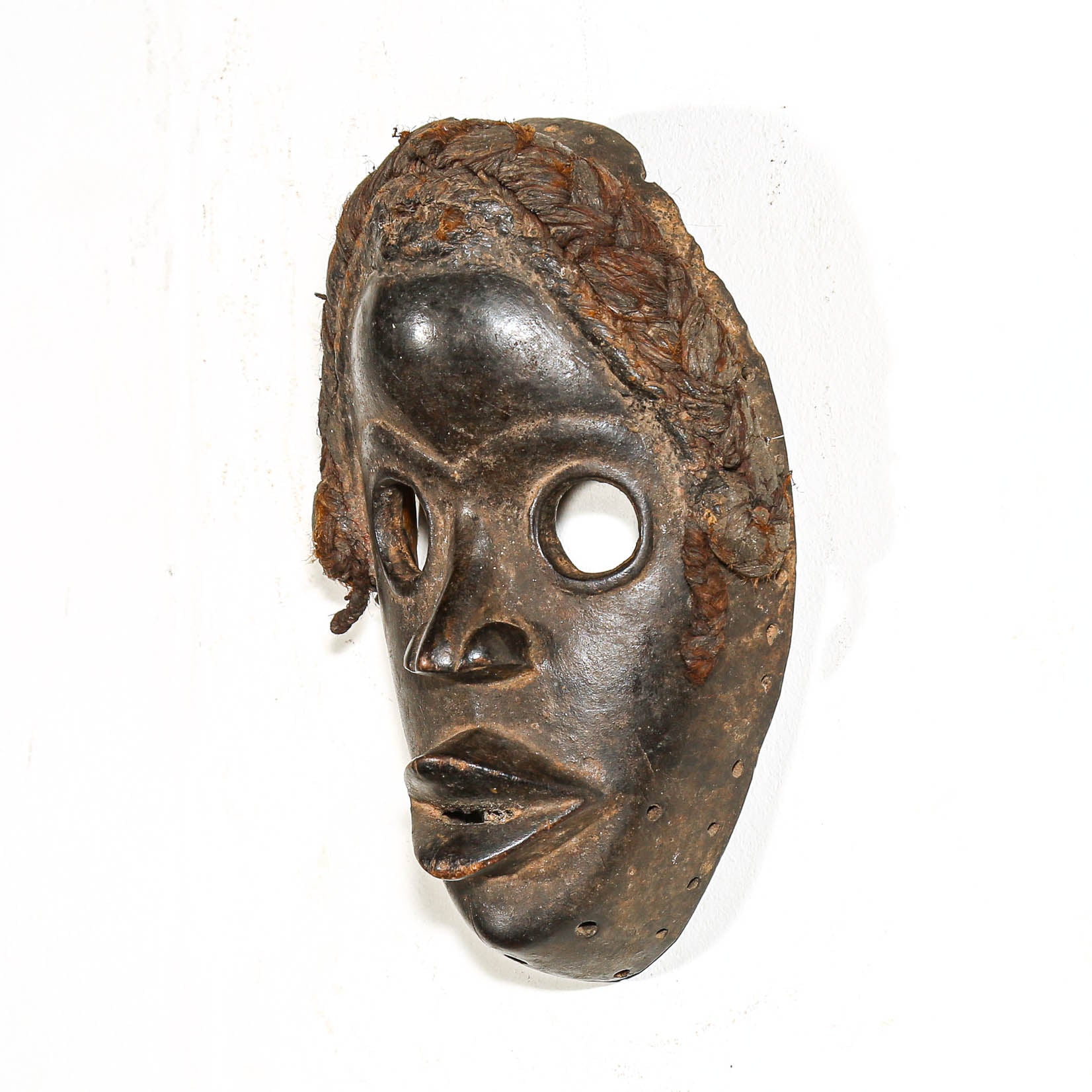 Black Traditional tribal wooden mask on a white background from Africa
