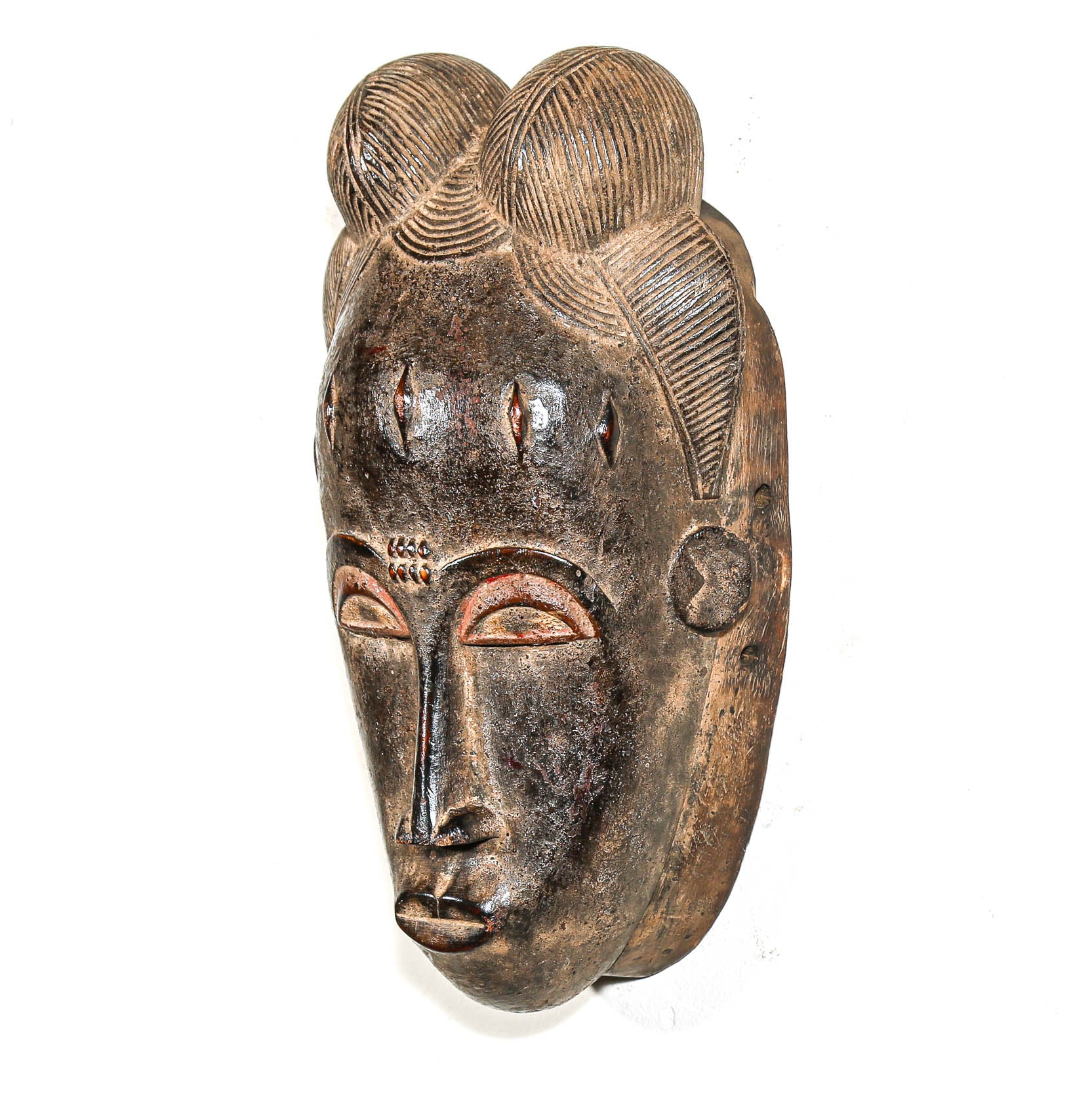 African mask with detailed black facial features on a white background