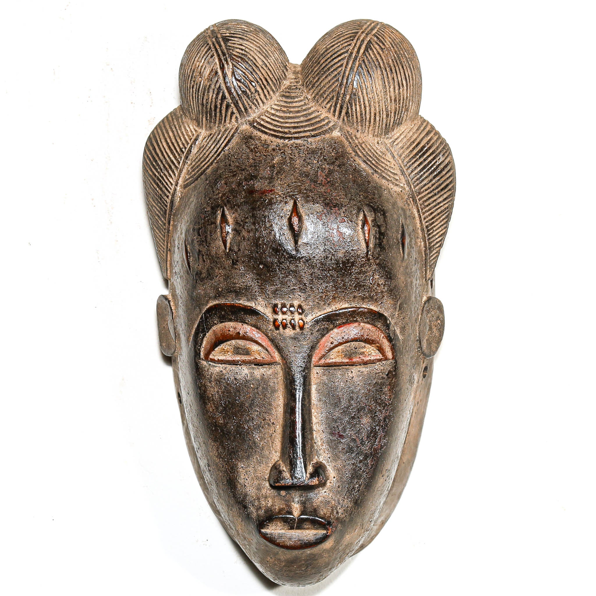 African black art mask with intricate designs on a white background