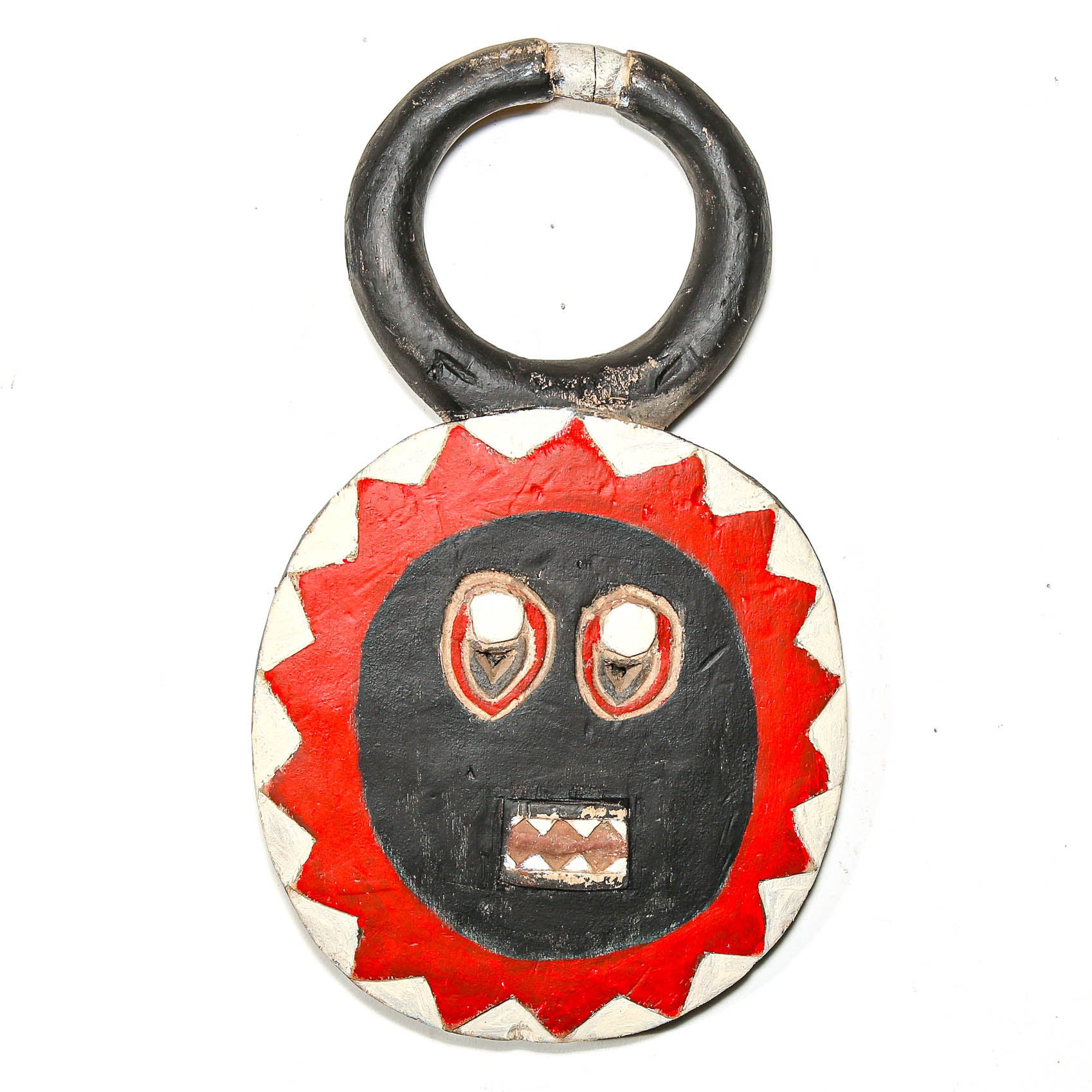 Round wooden African mask with a red and black face design on a white background