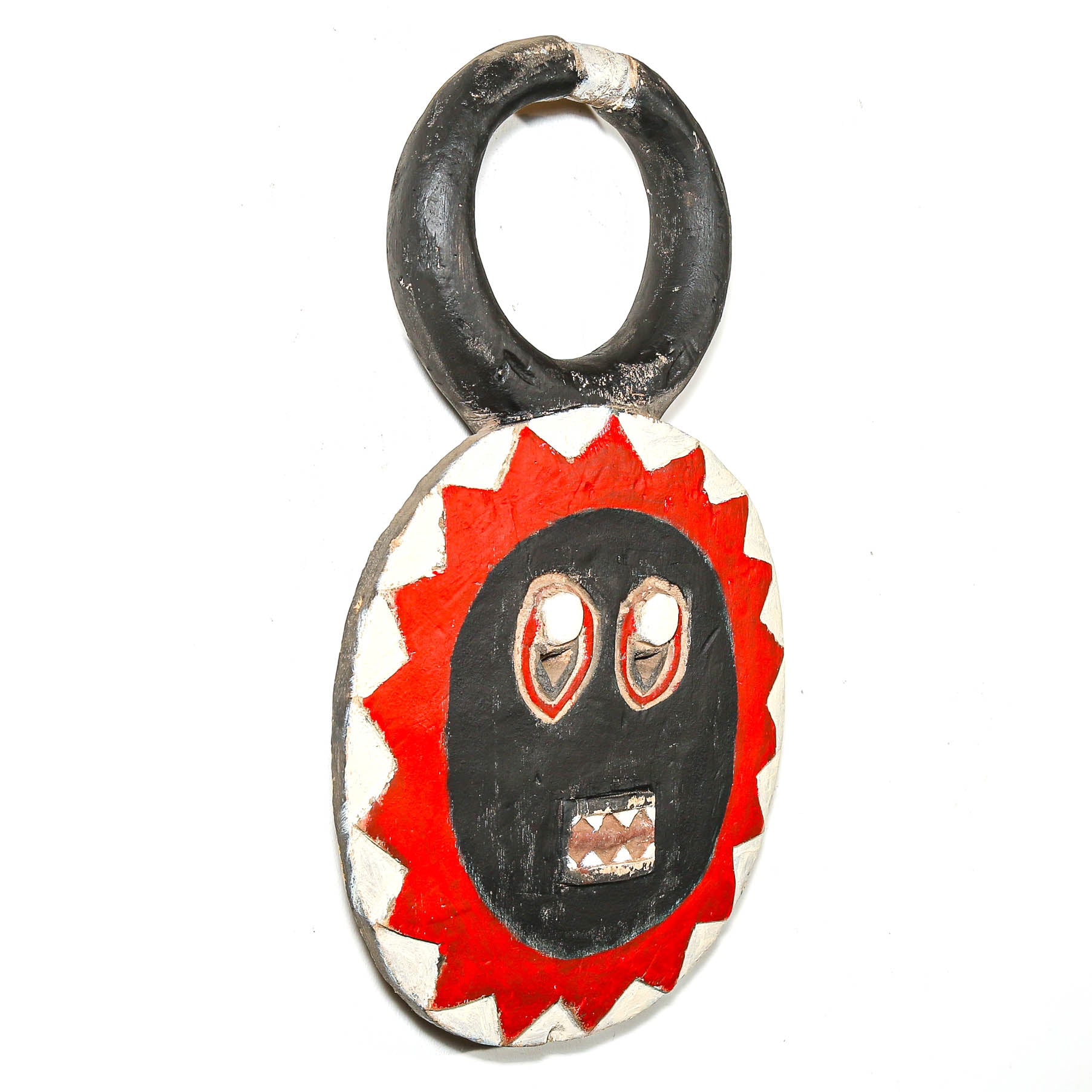 Round wooden African mask with a red and black face design on a white background