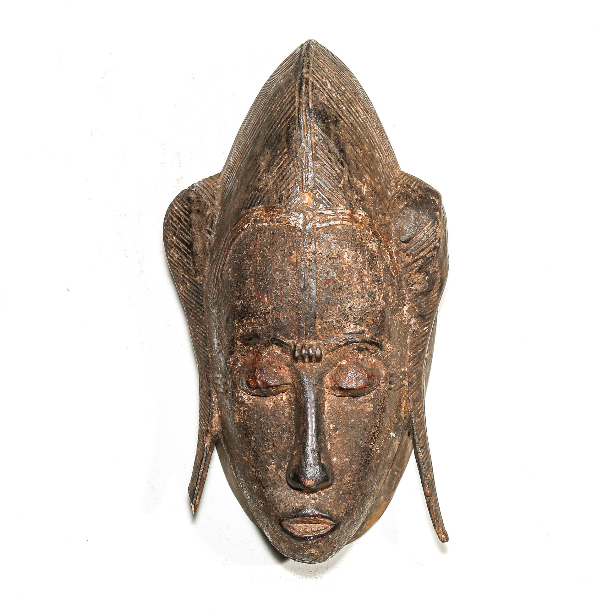 Wooden mask with intricate carvings on a white background