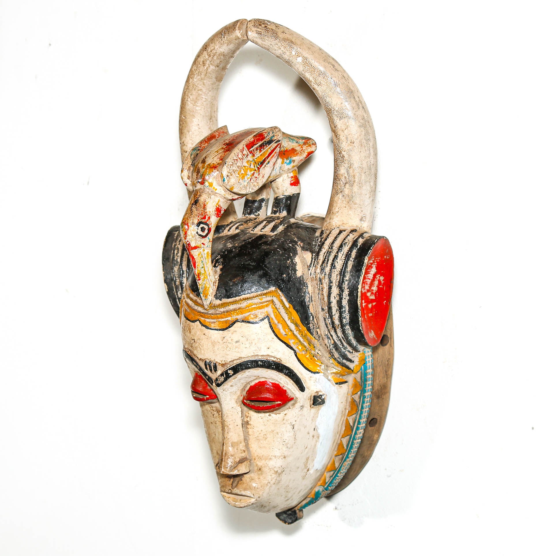 Decorative mask from Africa for sale with animal features on a white background