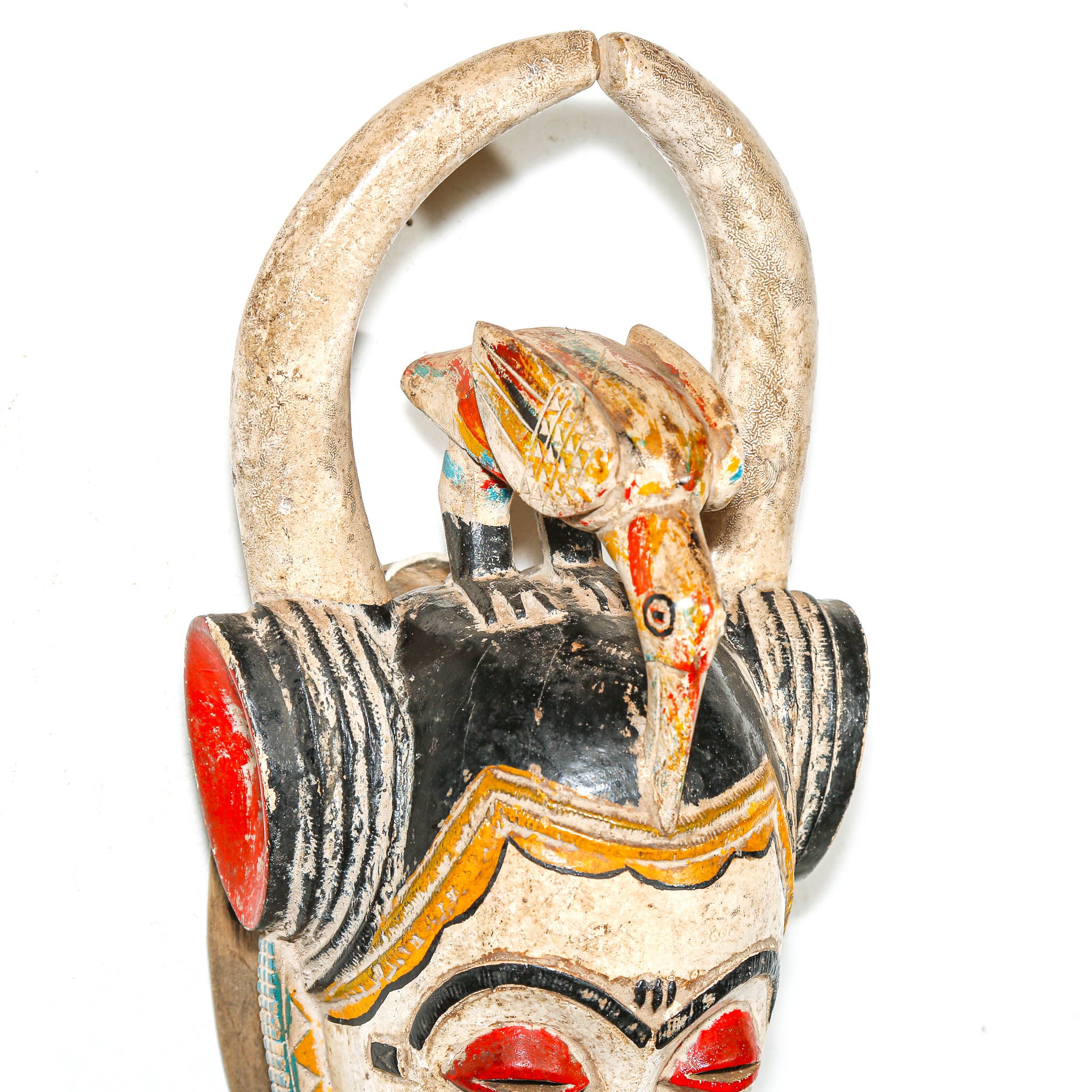 wooden african mask with colorful design on a white background for hang on the wall