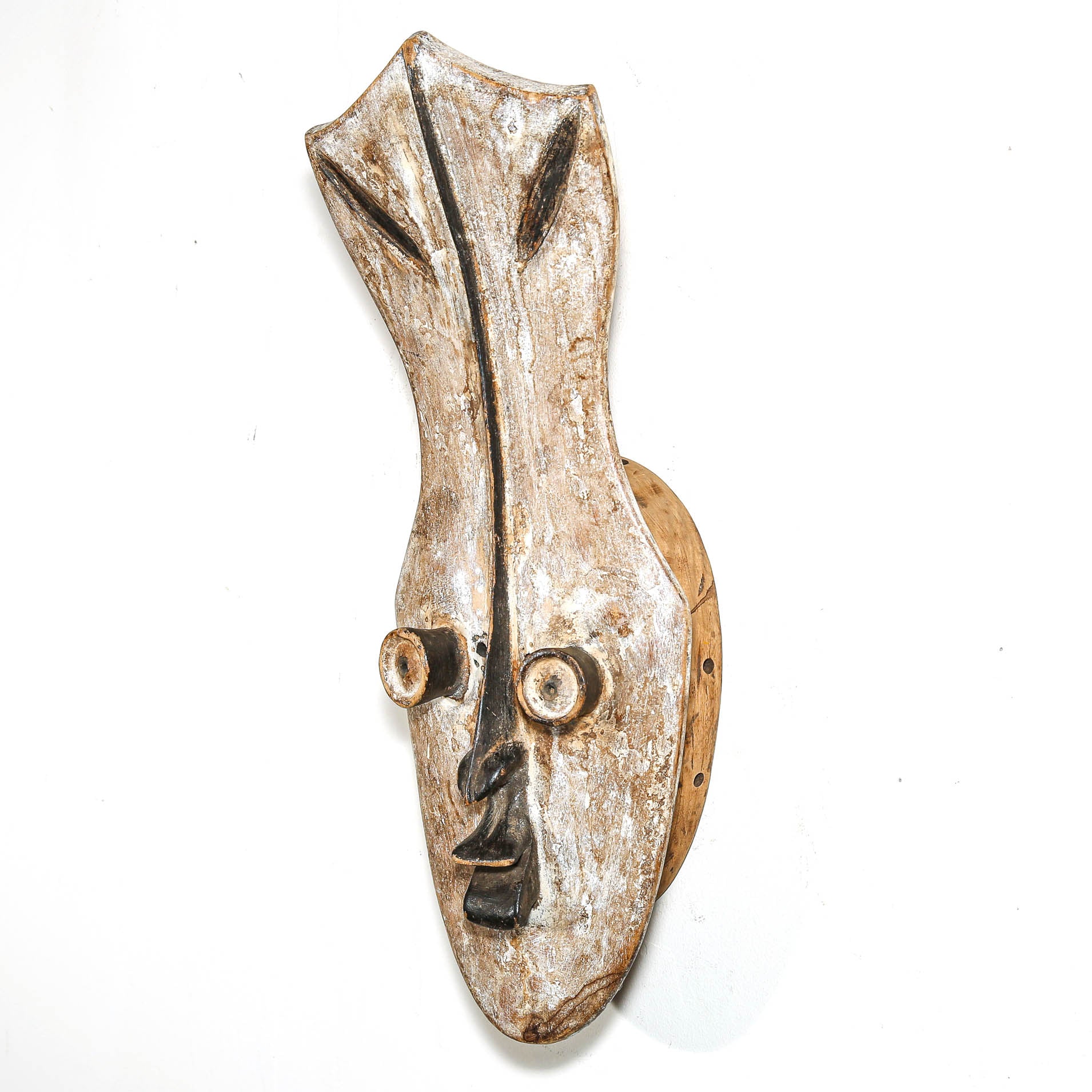 Decorative wall piece with a face design on a white background