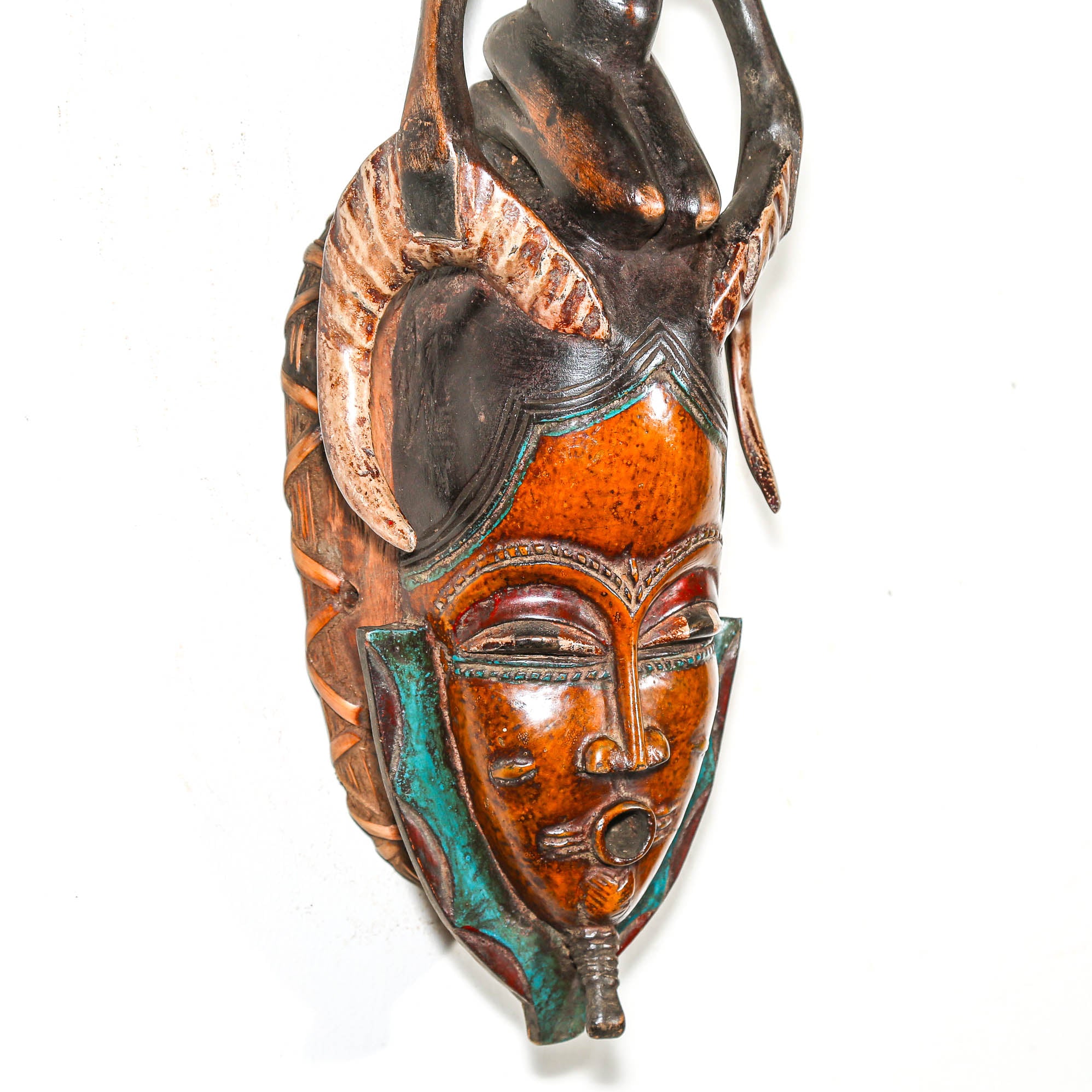 Decorative mask with intricate designs on a white background