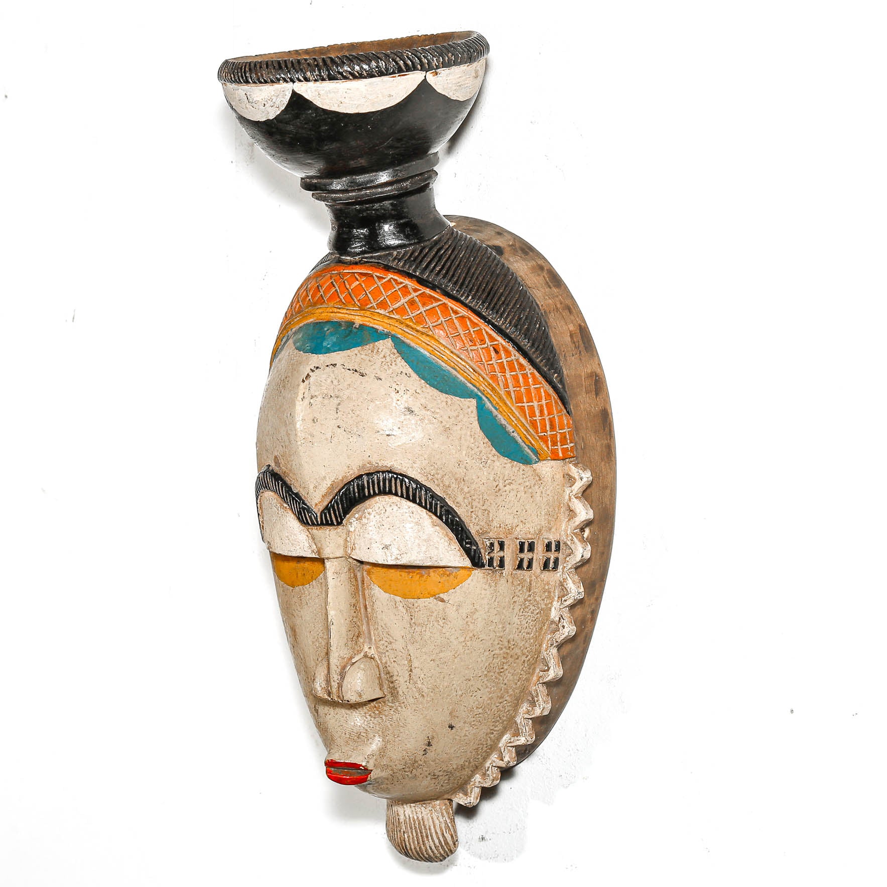 Decorative tribal art with face design on a white background