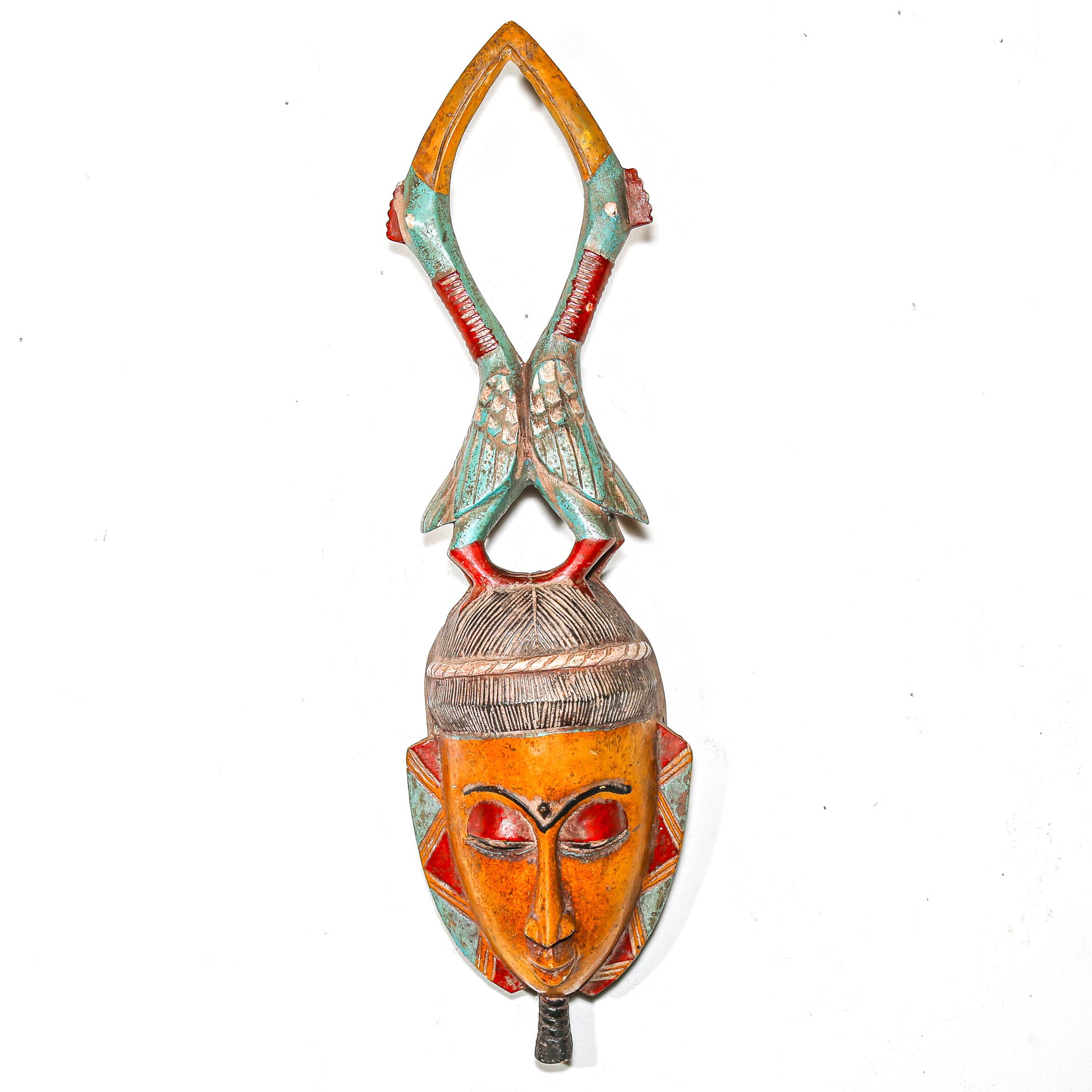 Colorful wooden mask with intricate designs on a white background