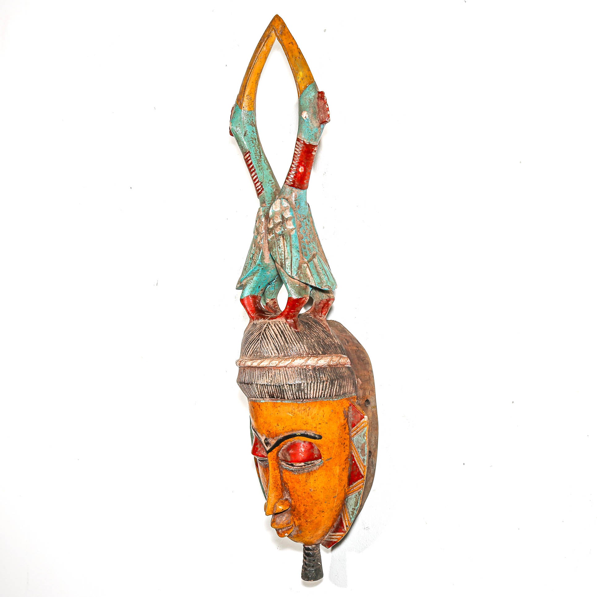 Decorative mask with colorful carved birds on a white background