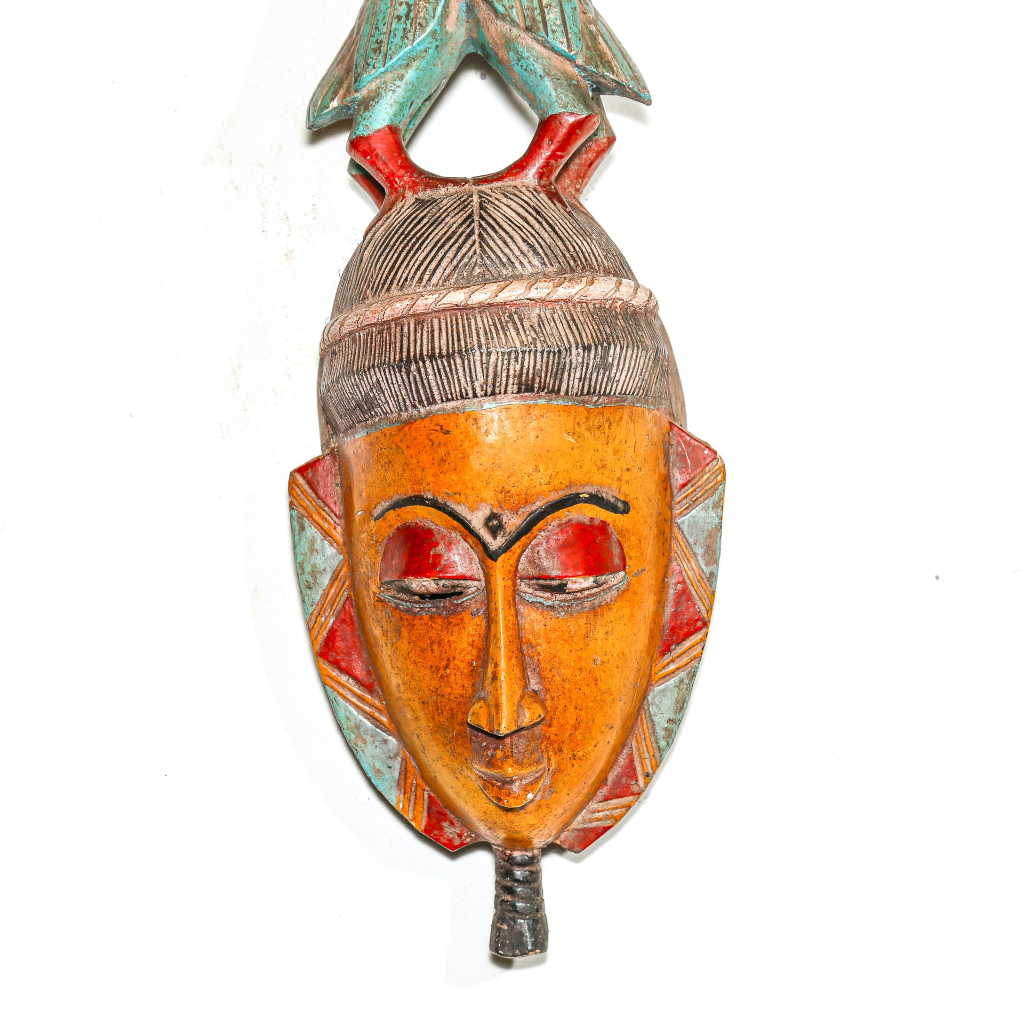 Decorative mask with colorful design on a white background