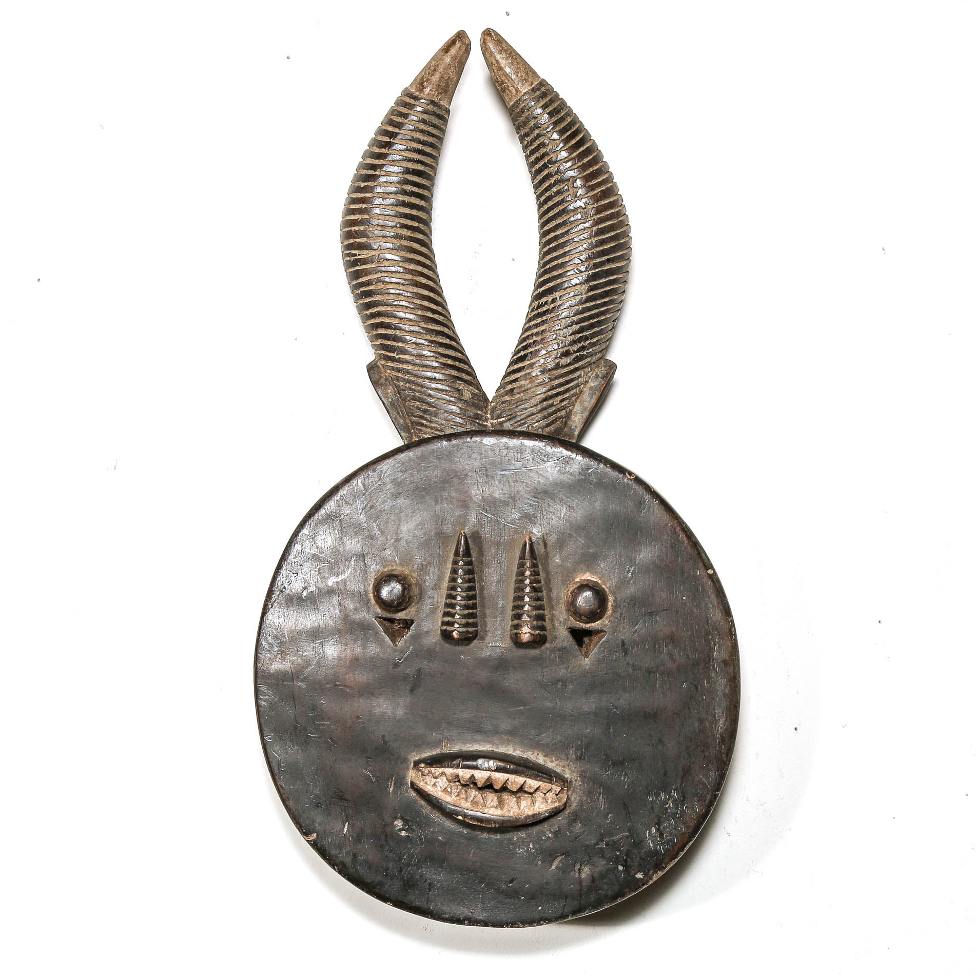 Decorative black african mask with antelope horns on a white background