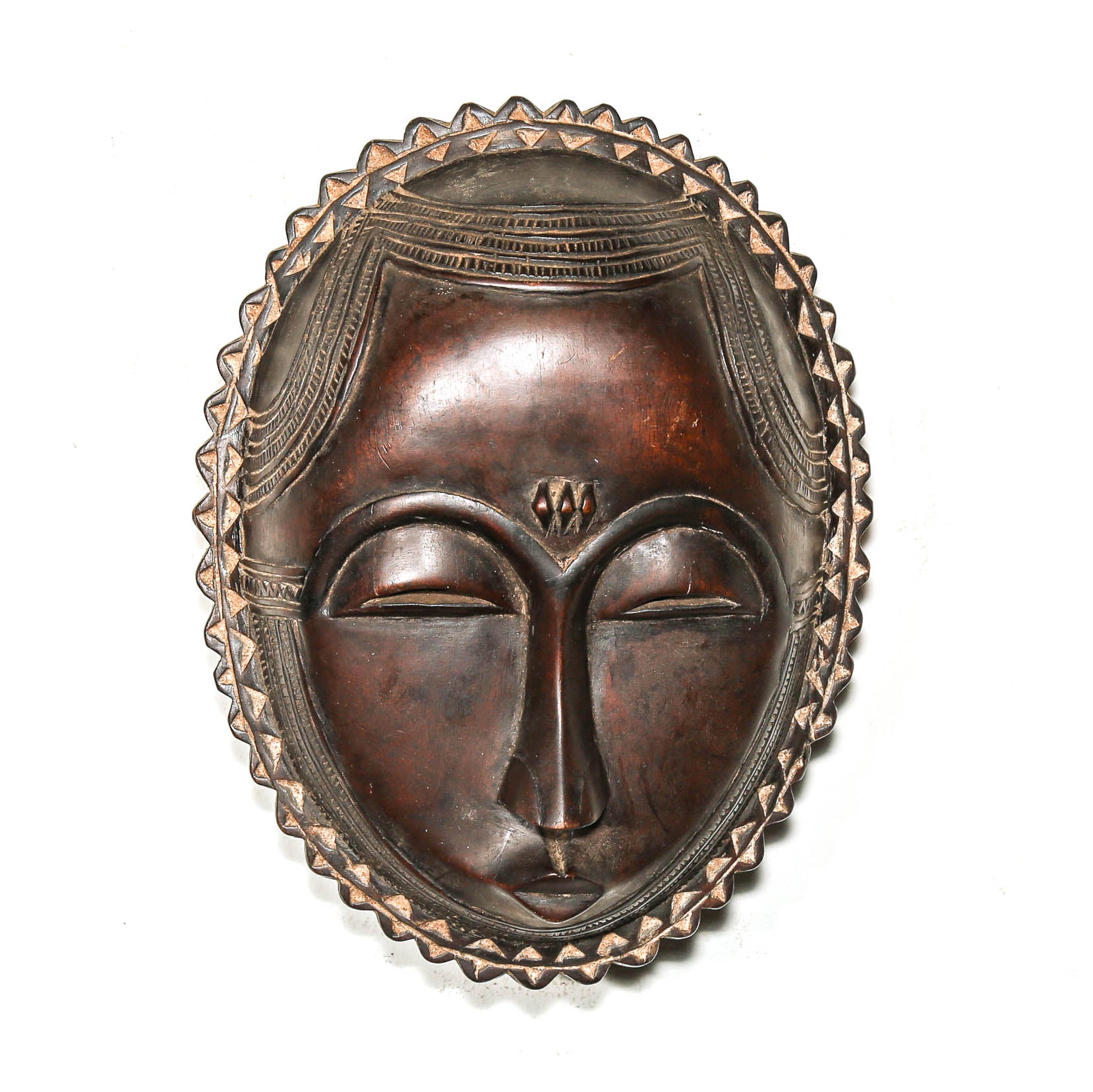 Decorative African mask with intricate designs on a white background