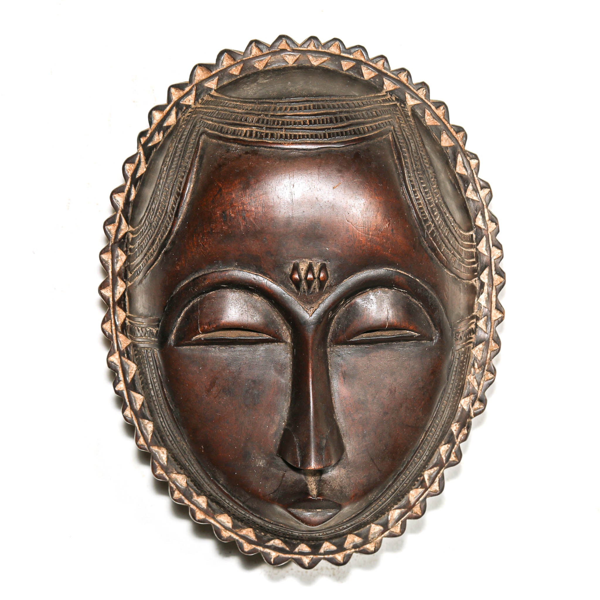 Decorative mask with intricate designs on a white background