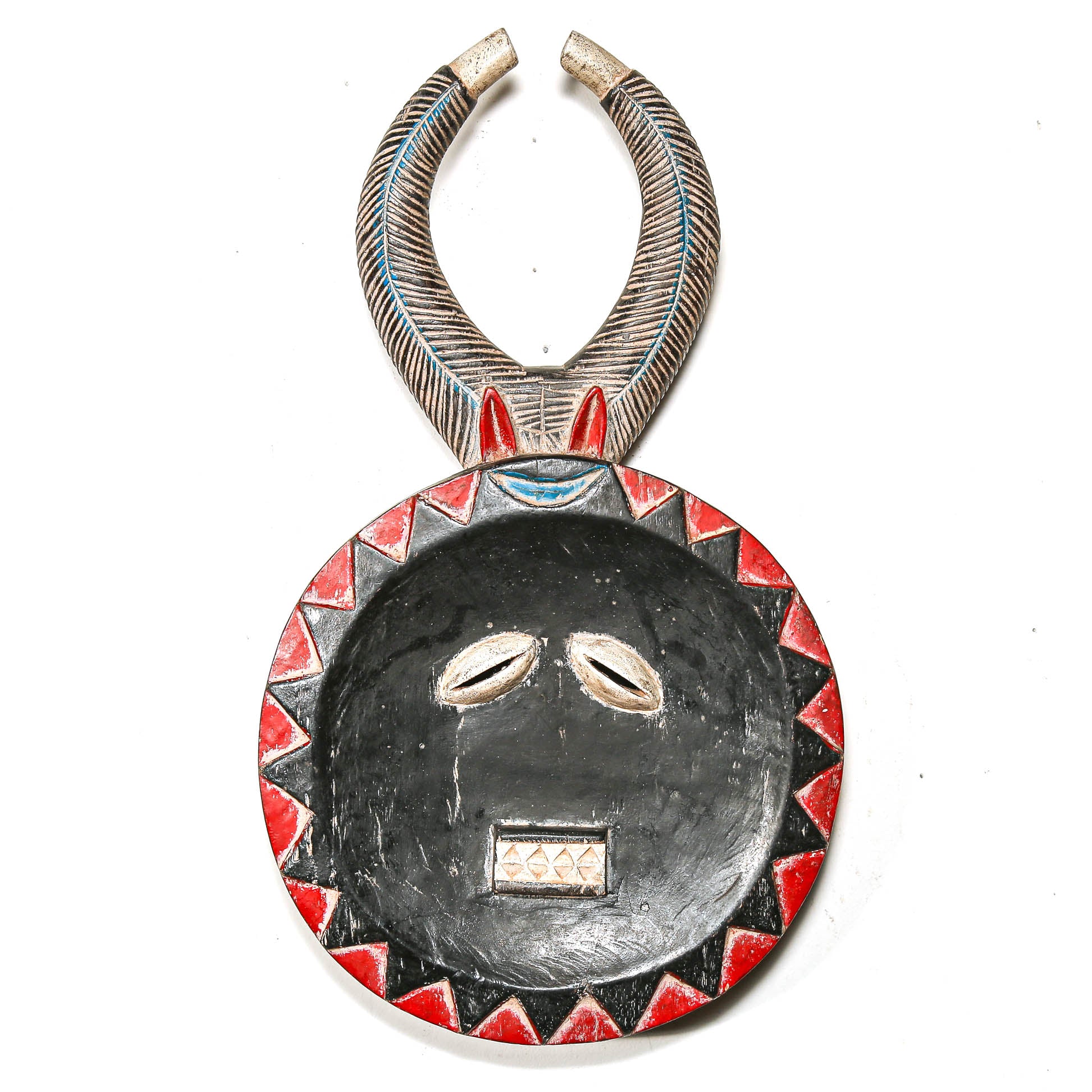 Decorative ceremonial tribal African art mask with red and black patterns on a white background