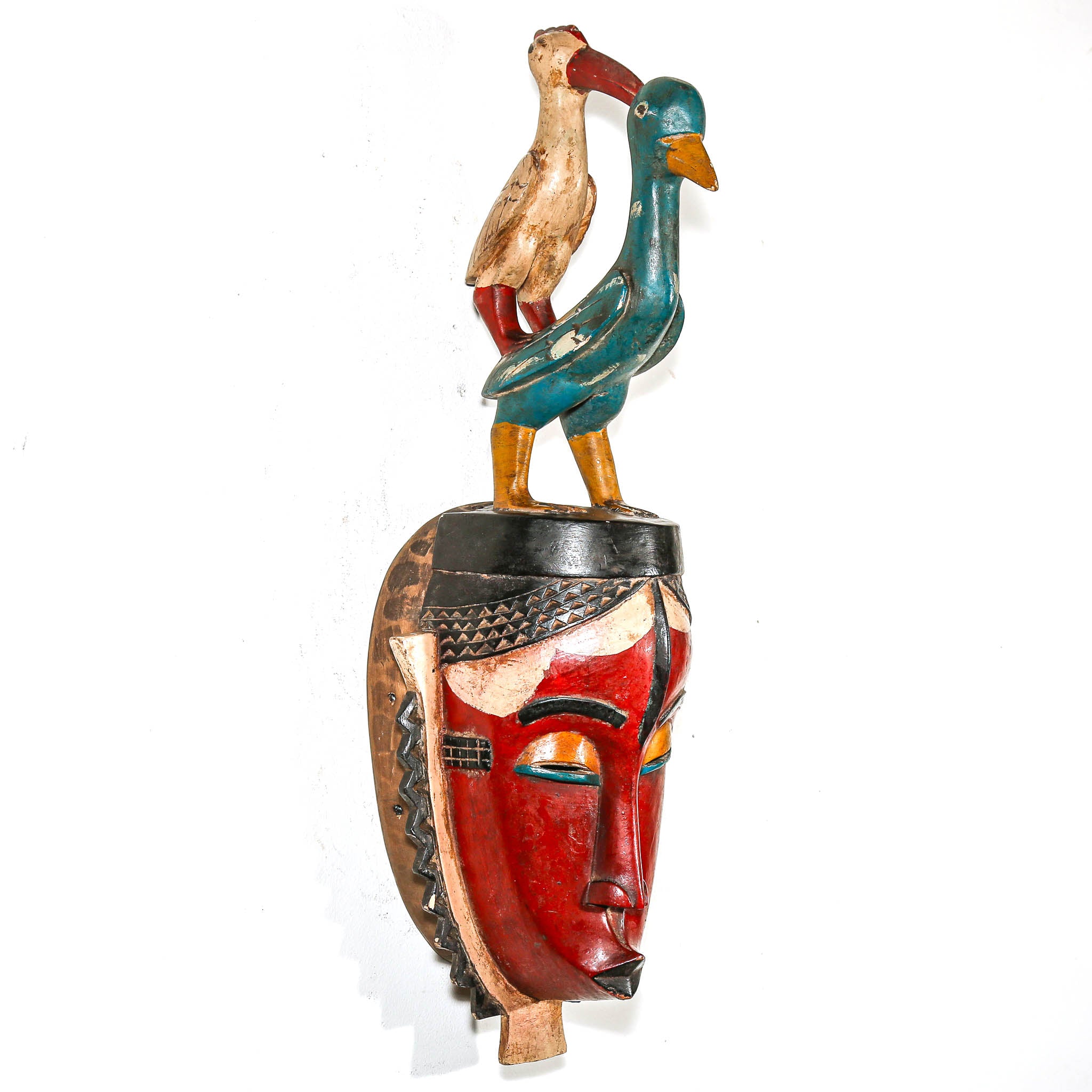 red african Decorative mask with two birds on top against a white background