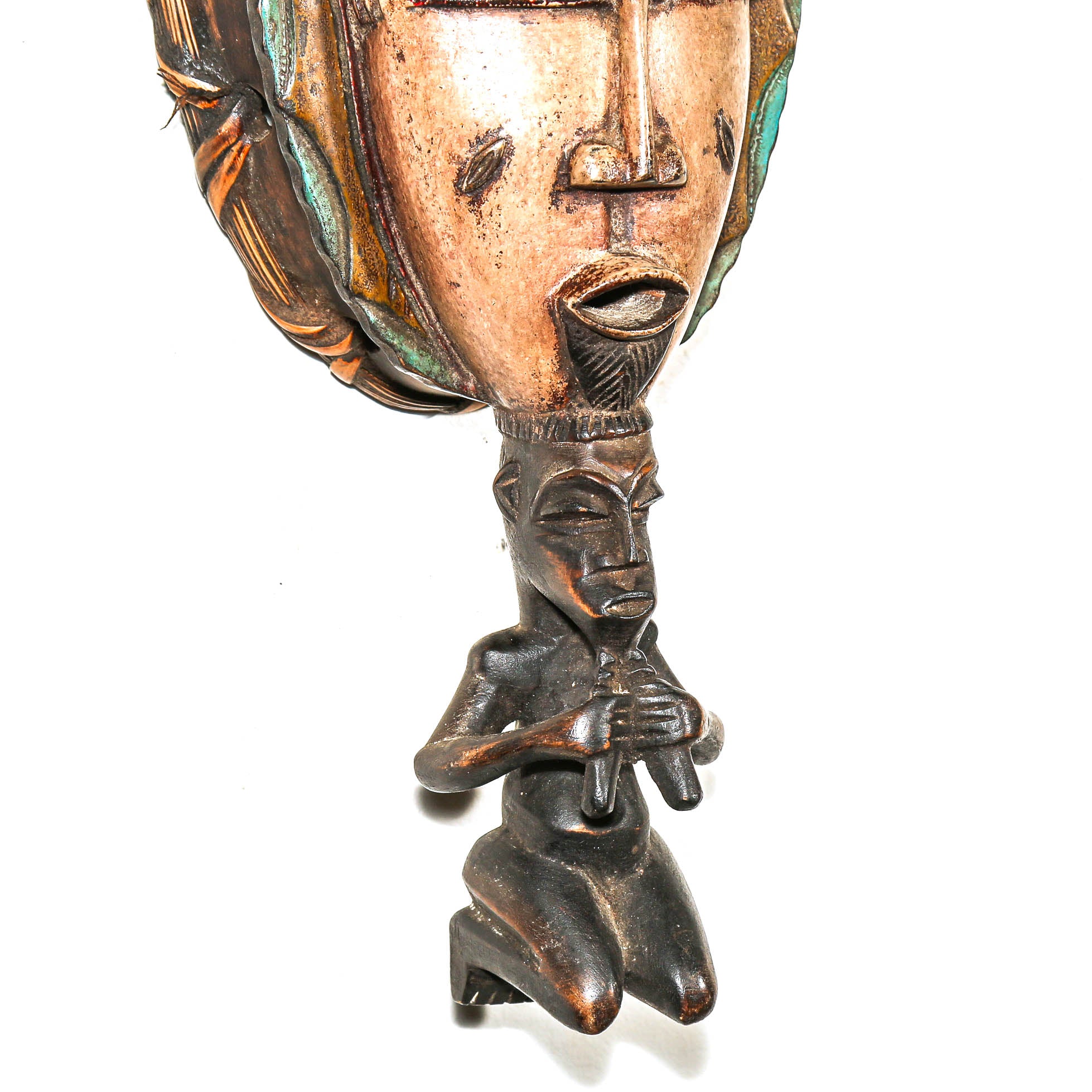 Detail of the carved figure with detailed facial features on a white background