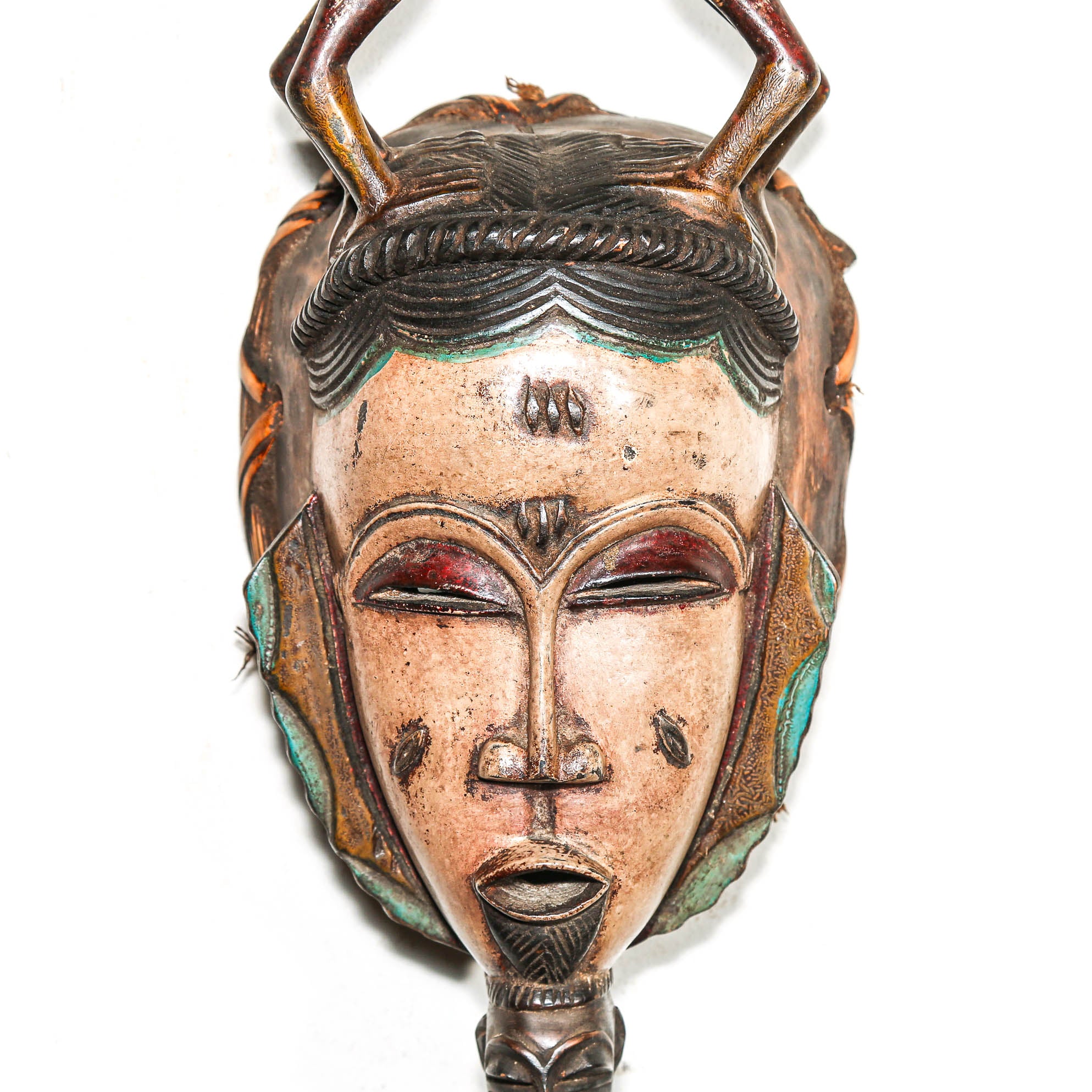 Decorative mask with intricate details on a white background