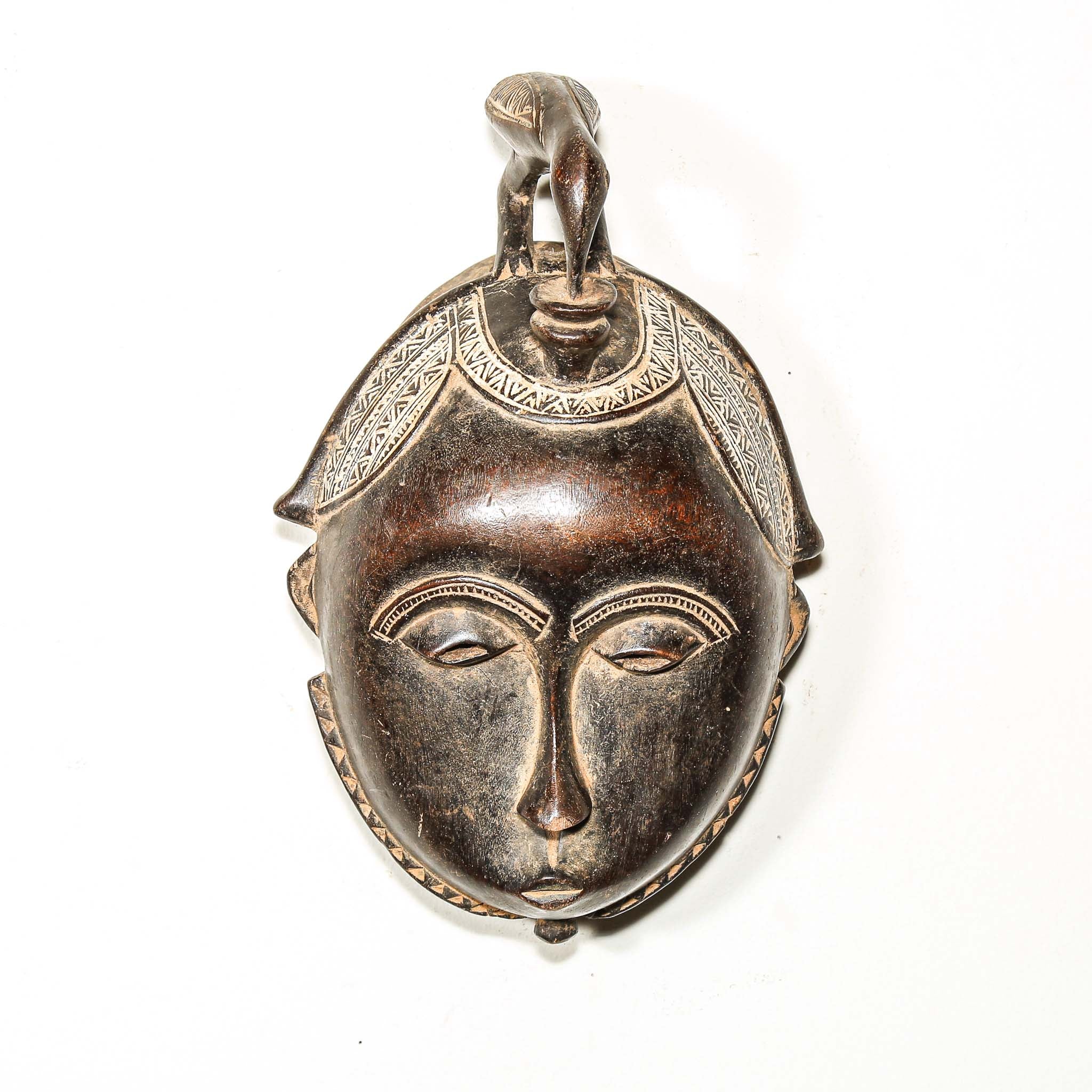 Decorative mask pendant on a white background