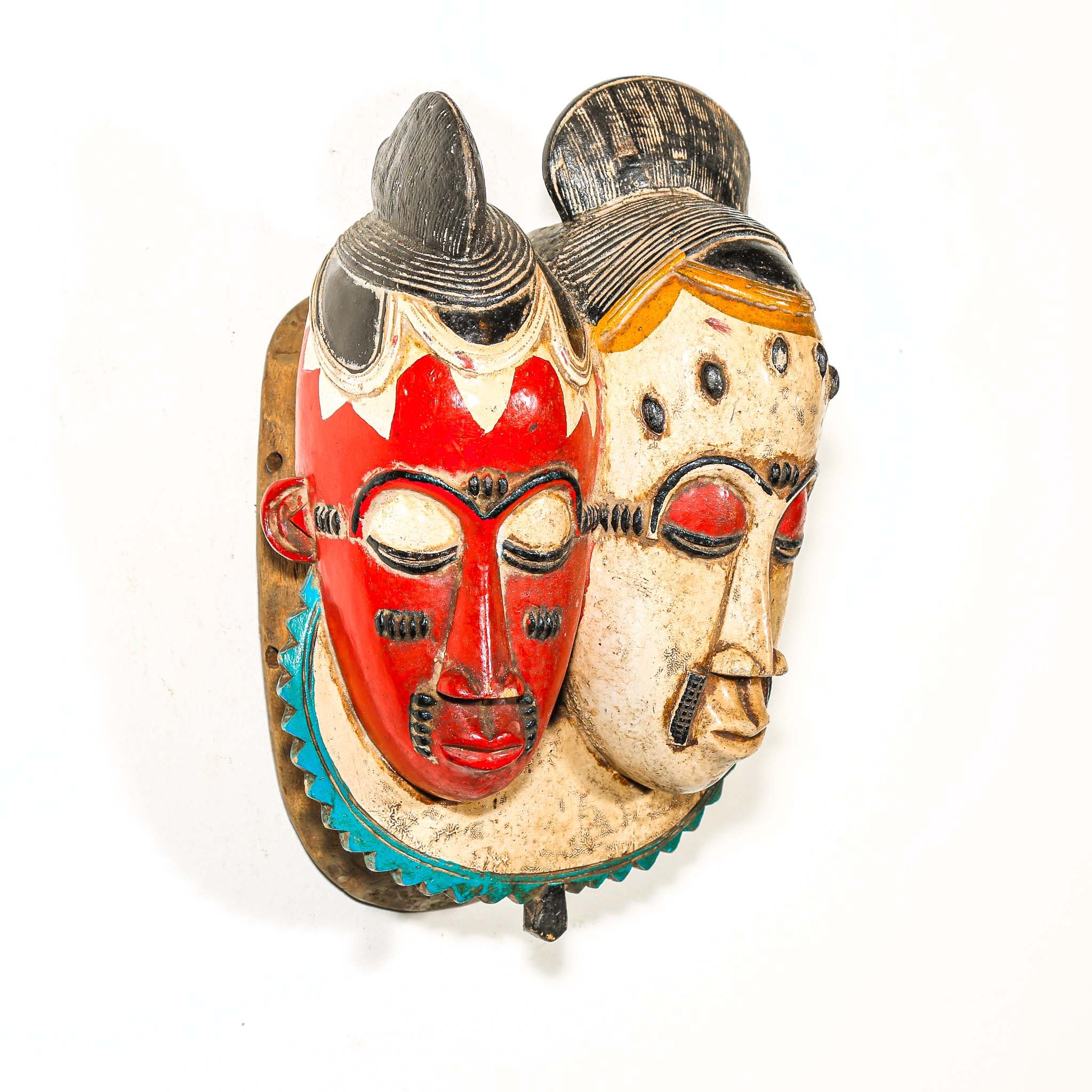 Decorative wall African tribal art mask with two faces, one red and one beige, on a white background.