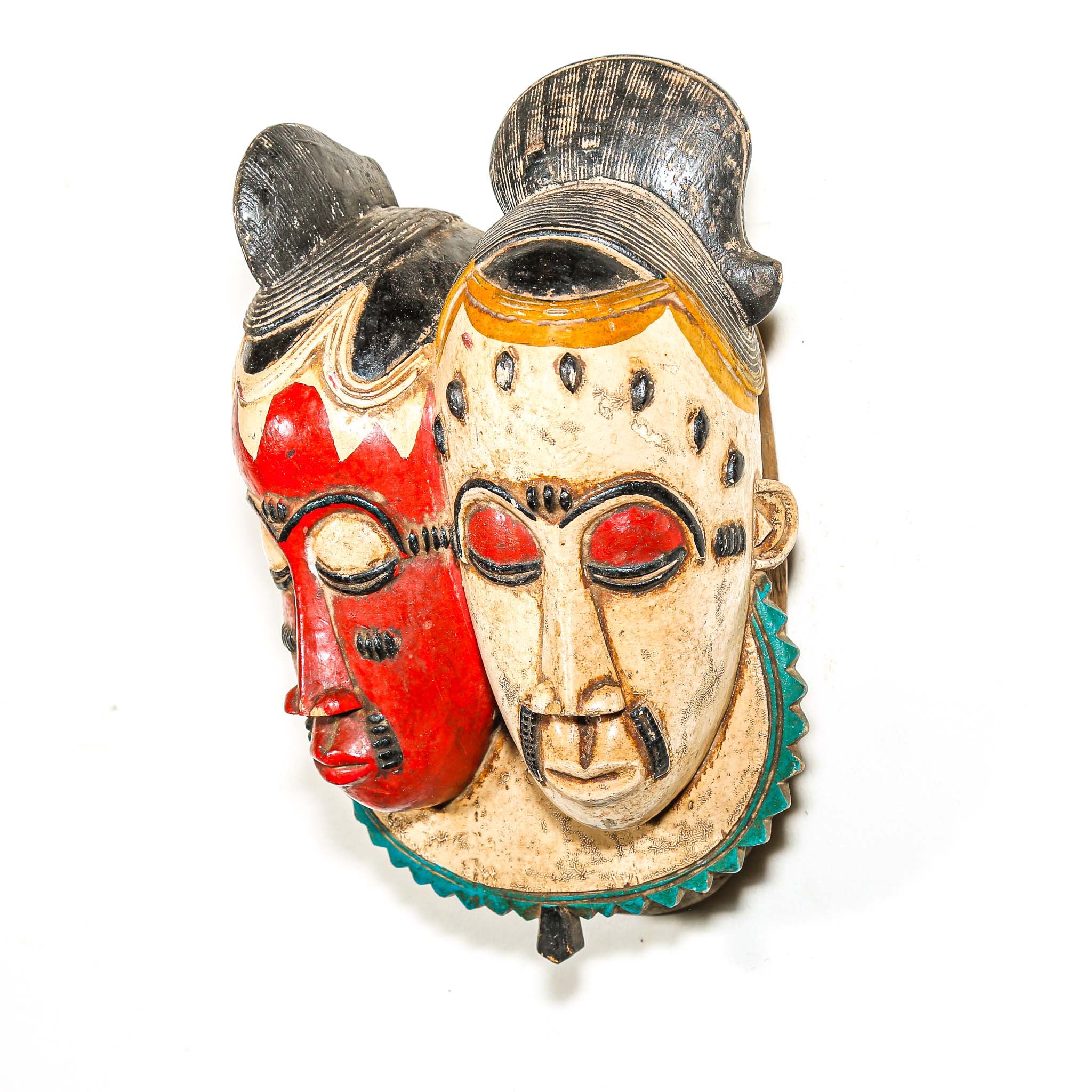 Decorative mask with red, beige, and green colors on a white background