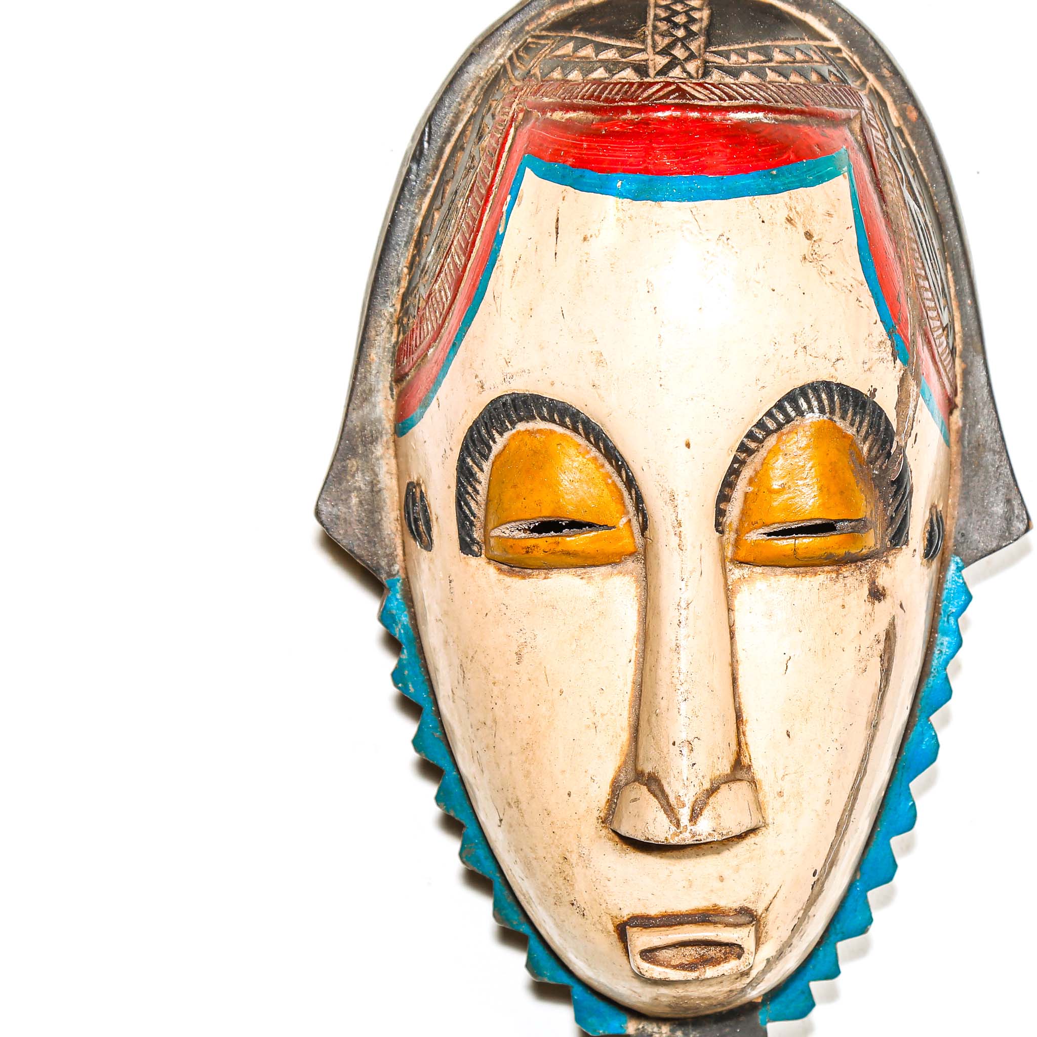 Traditional mask with colorful design on a white background