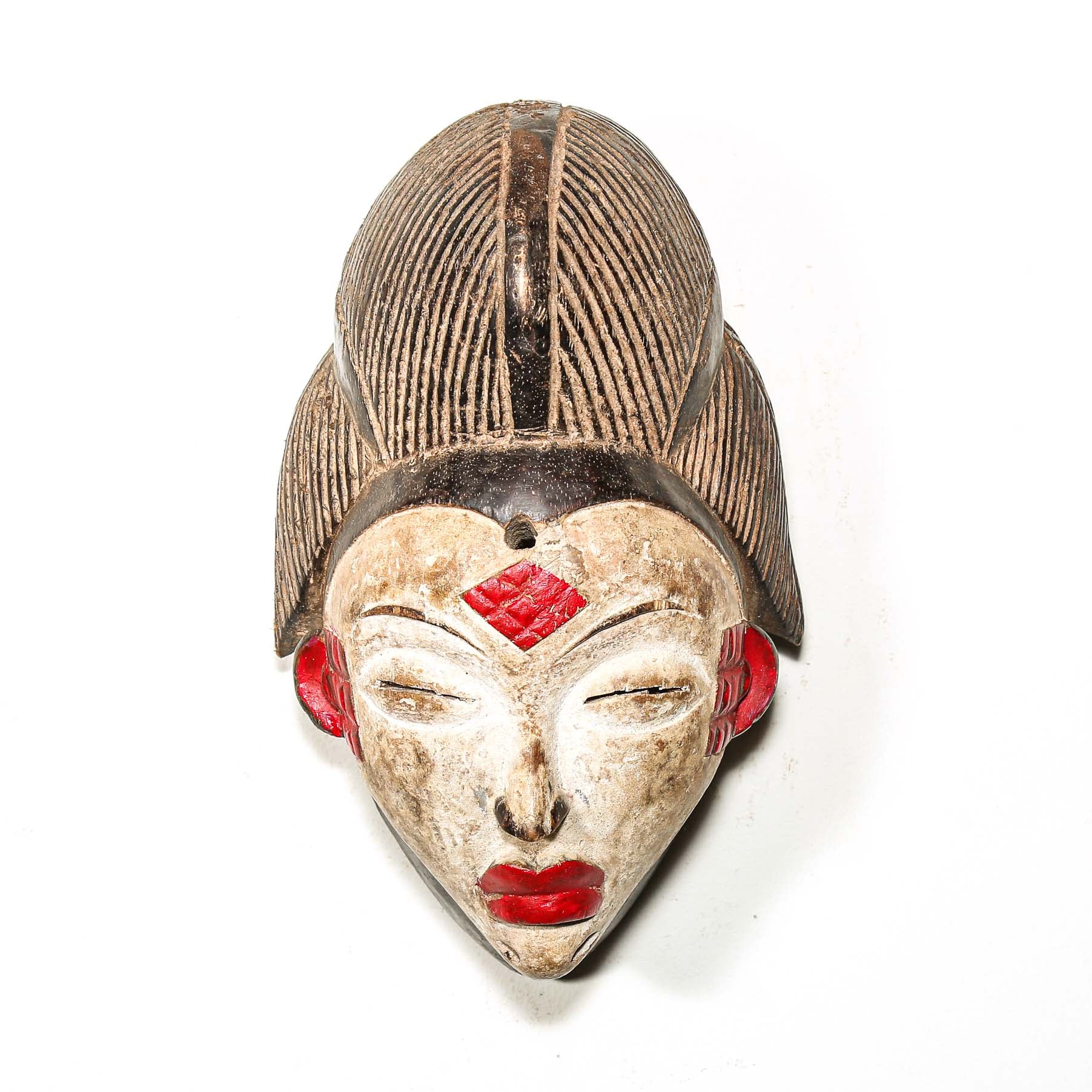 African-style wooden mask with red accents on a white background