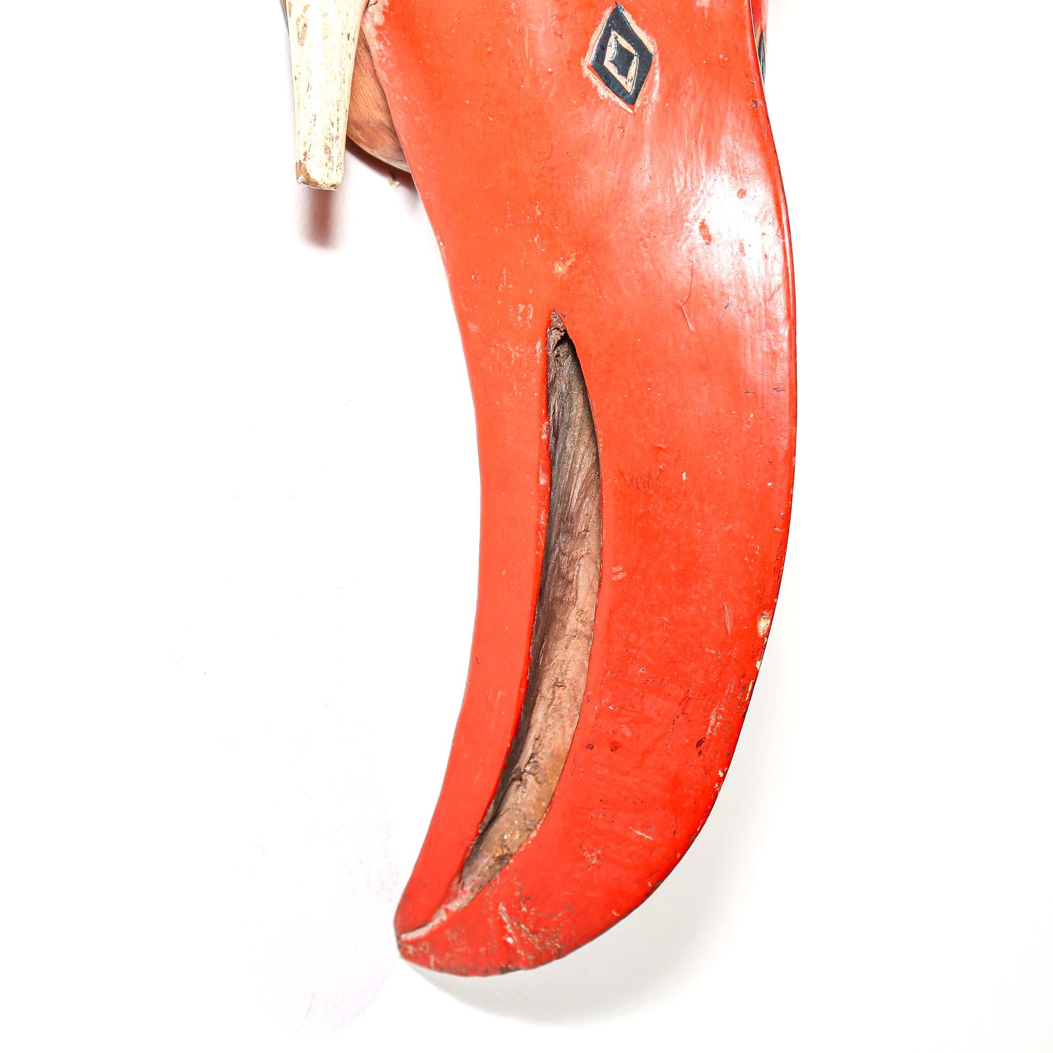 Close-up of the red bird beak on the mask on a white background
