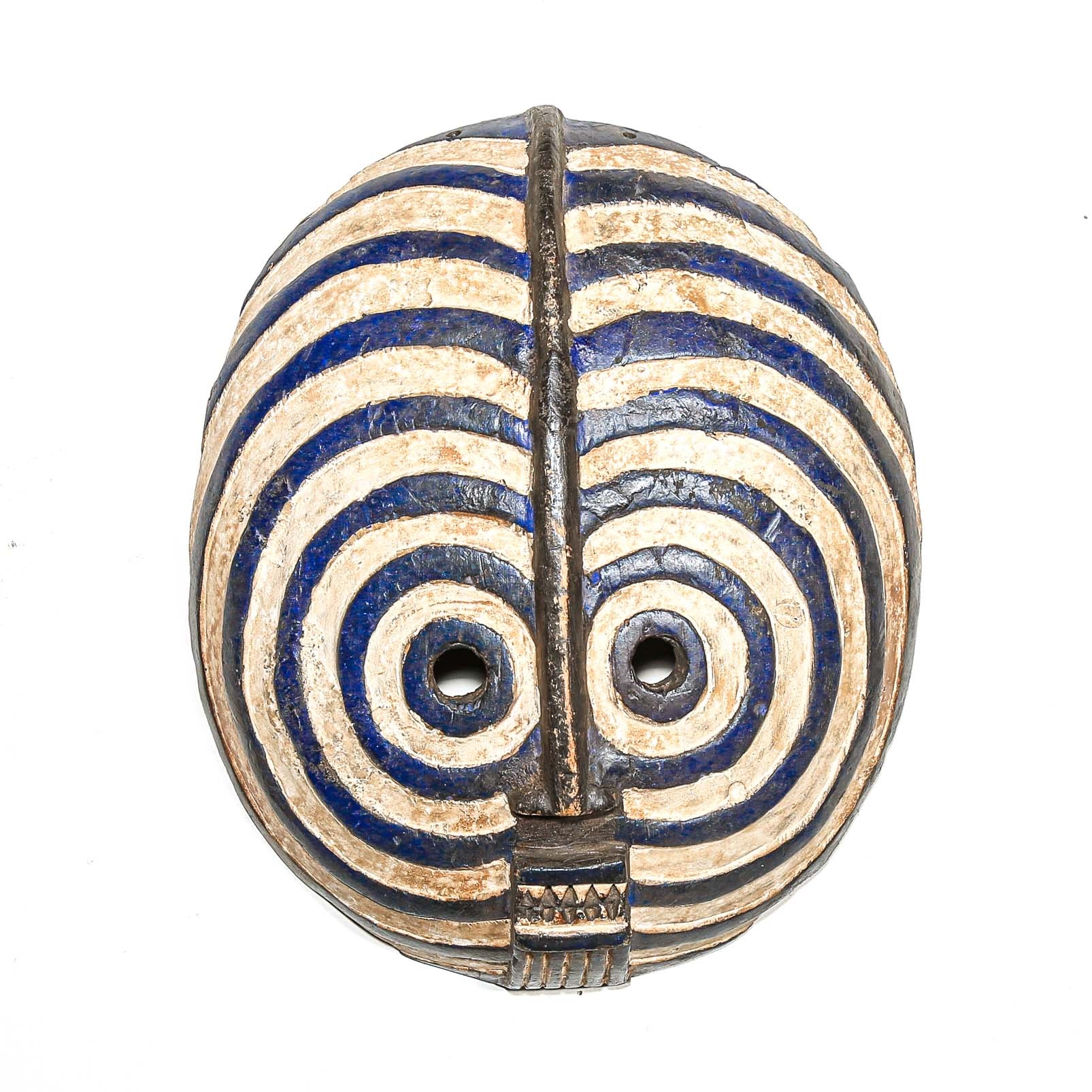 round Decorative African mask with blue and beige concentric circles on a white background