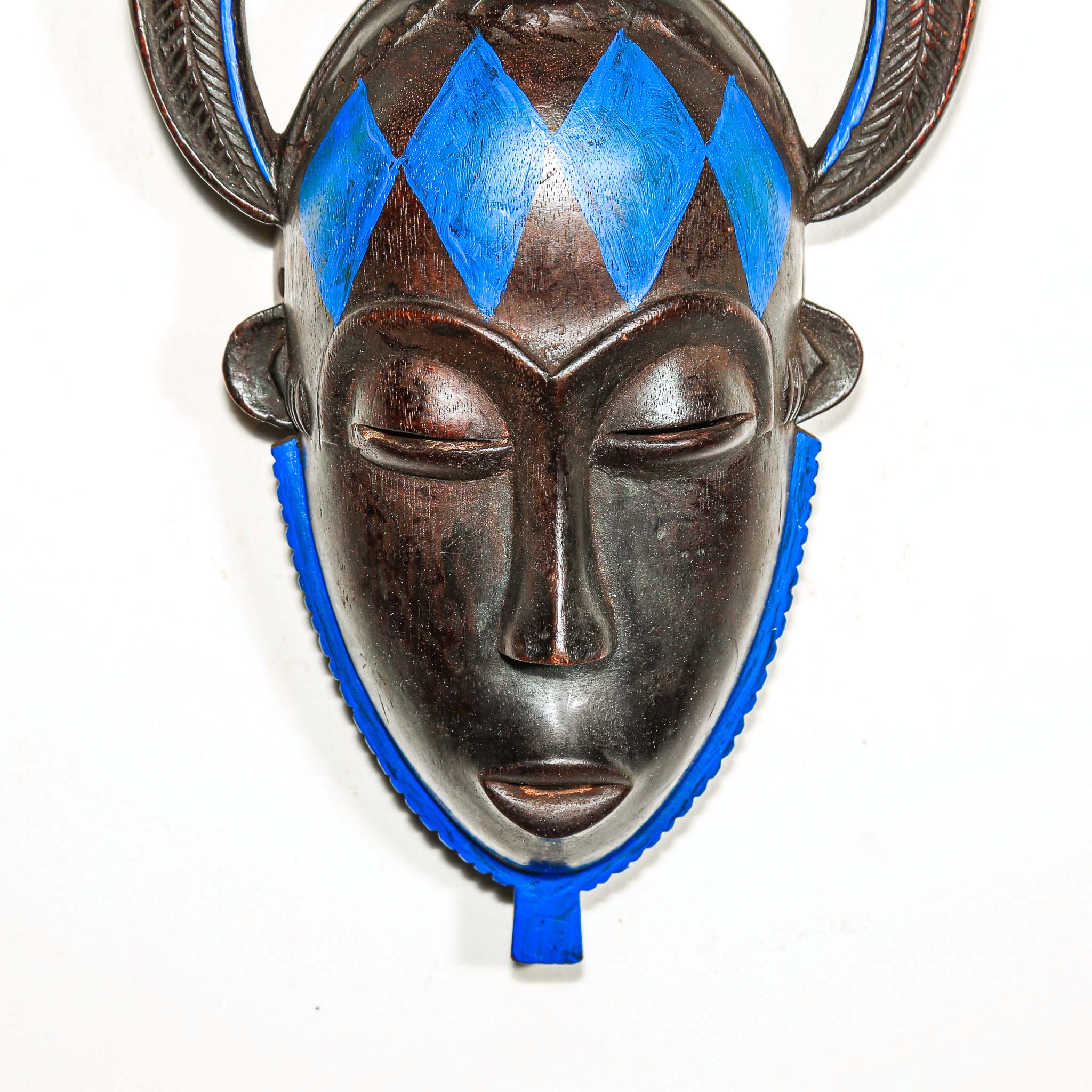African black Decorative mask with blue accents on a white background