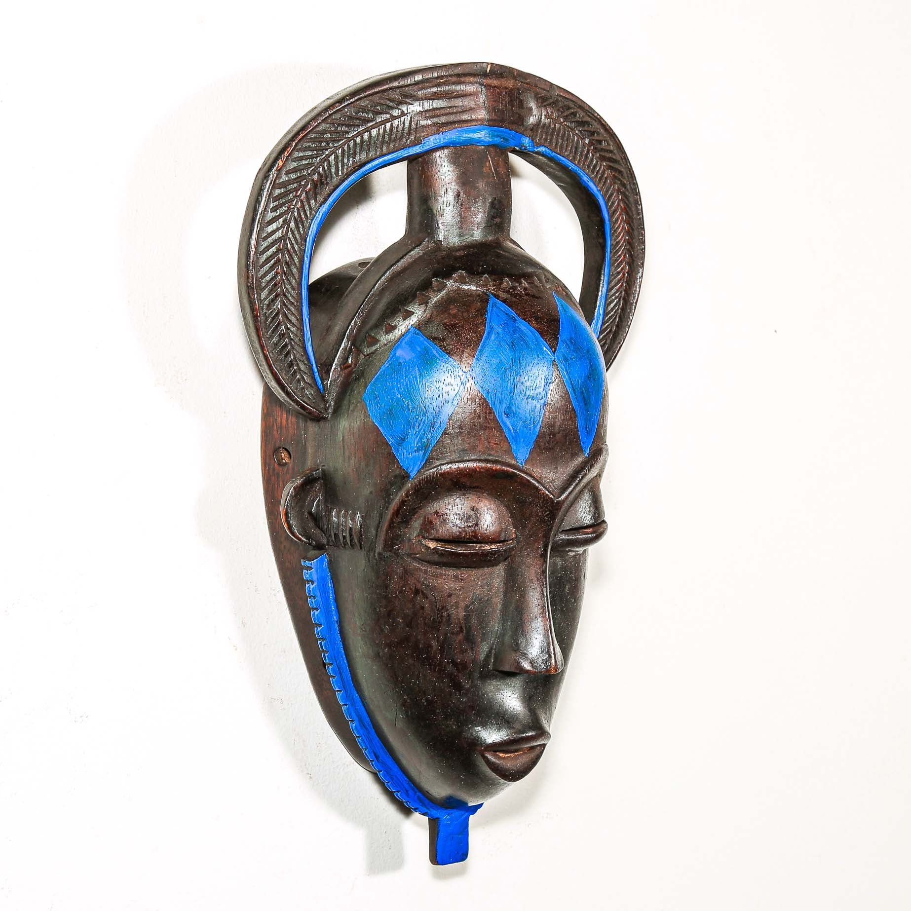 African black Decorative mask with blue accents on a white background