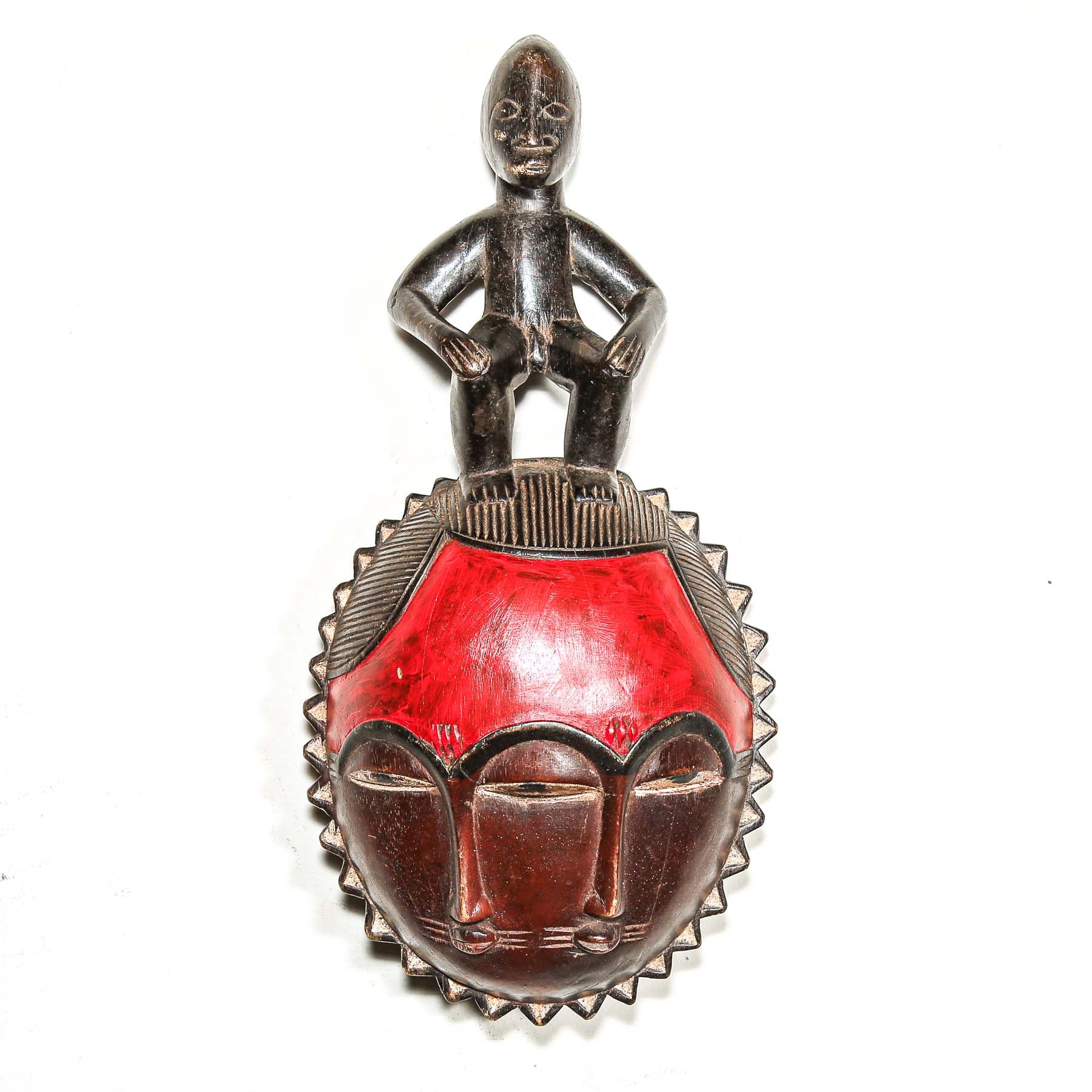 Decorative African wooden art figure  with red and brown design on a white background