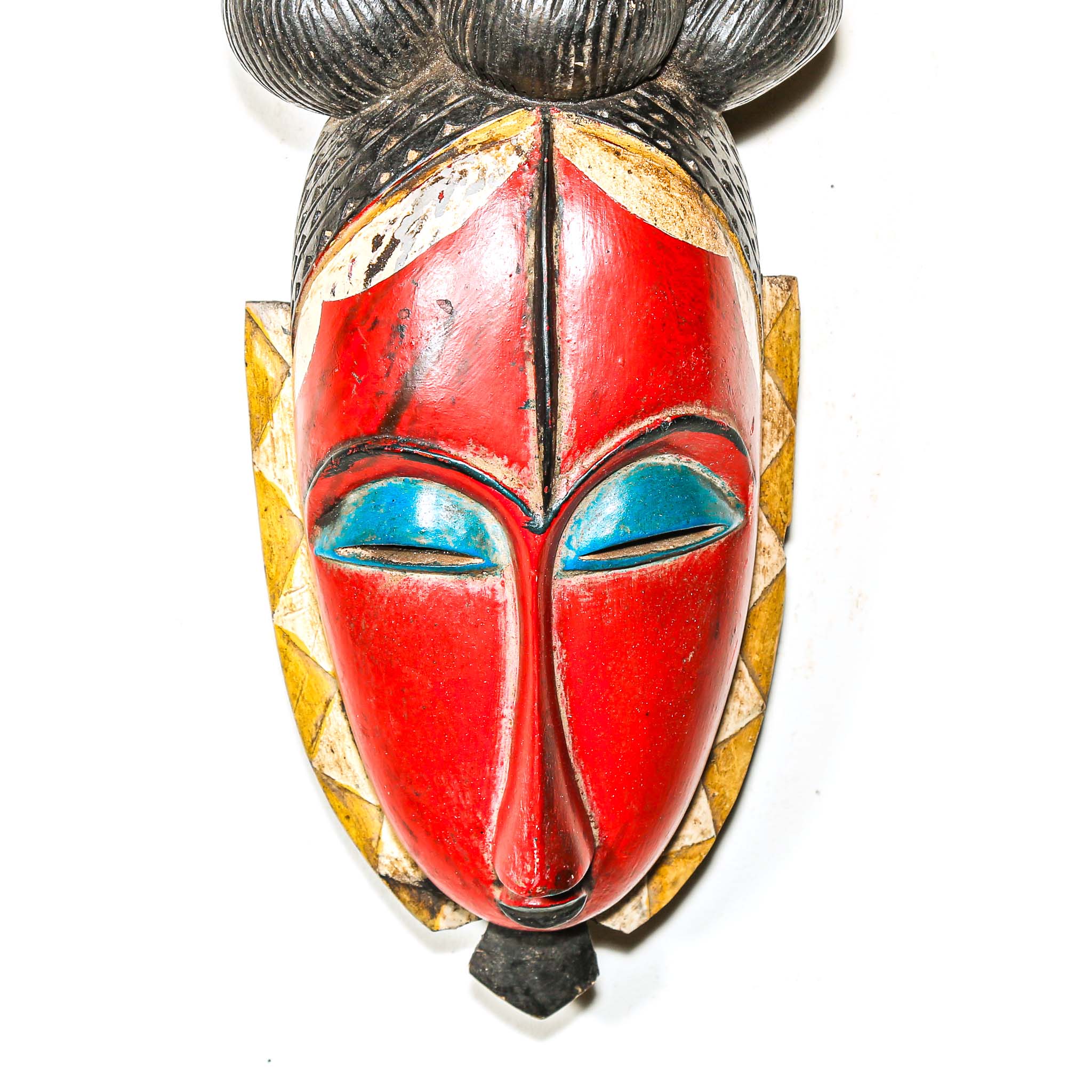 African decor mask with red face, blue eyes, and black hair on a white background