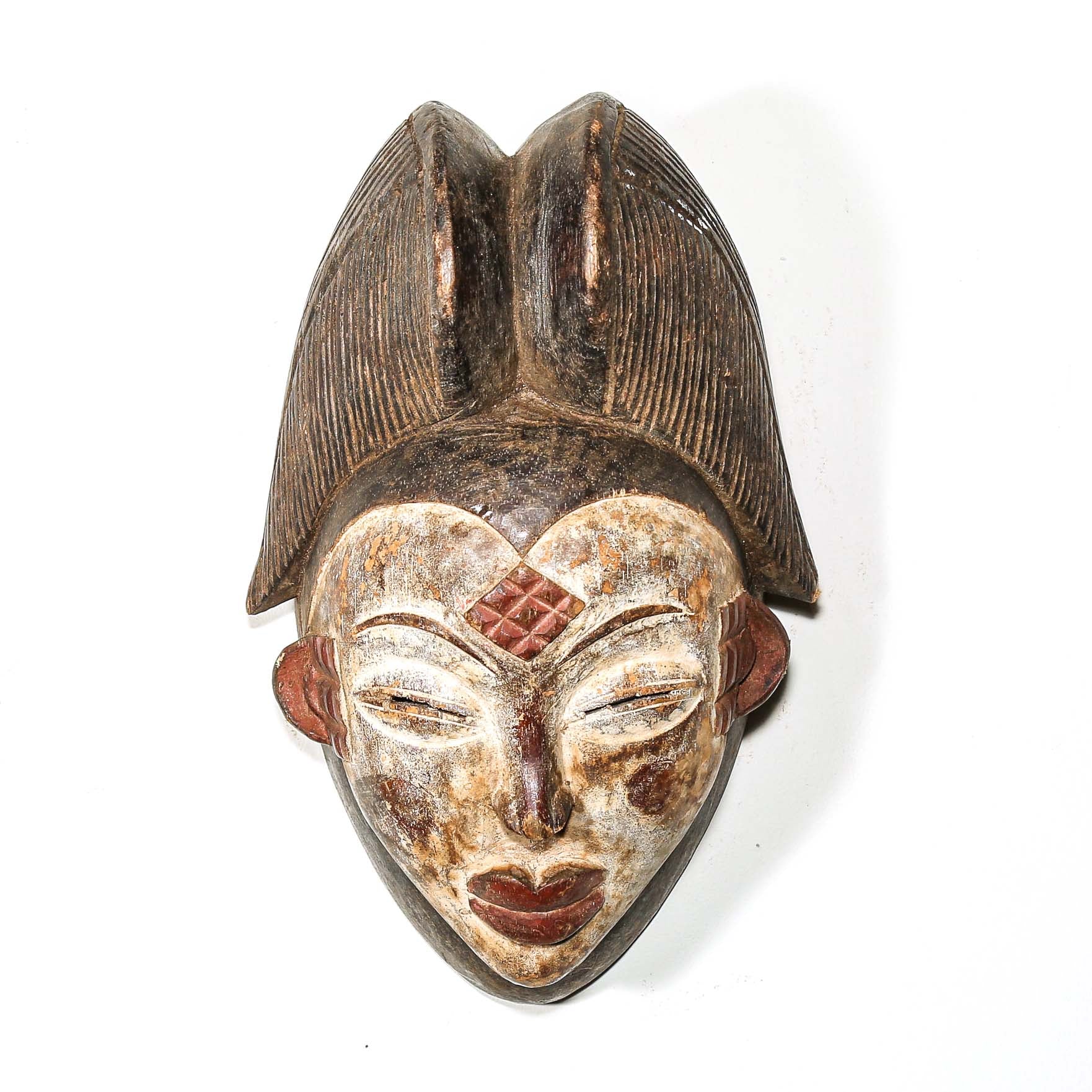 African mask with intricate designs on a white background