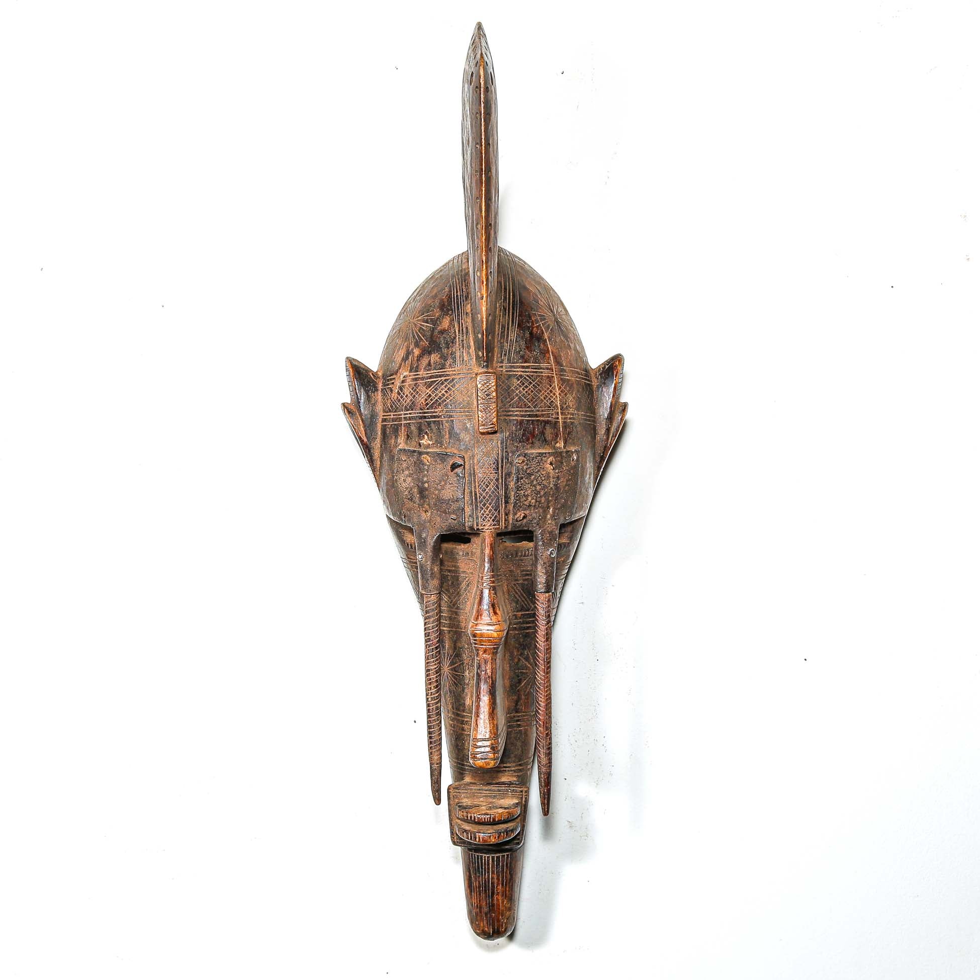 African Wooden and metal mask with intricate carvings for sale online
