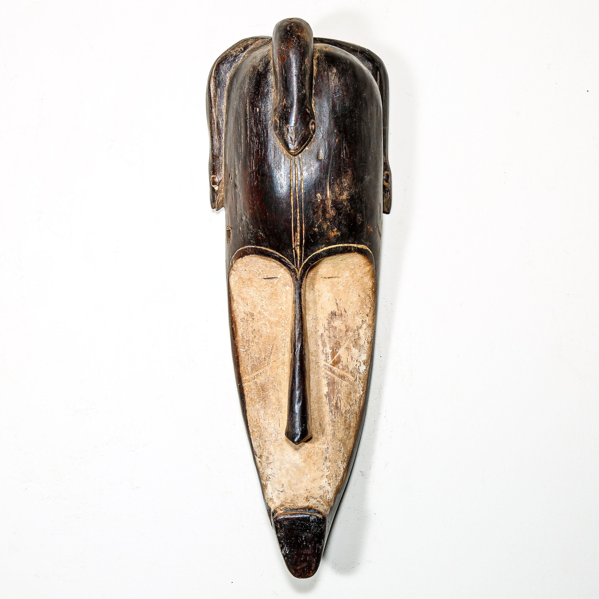 Wooden African vintage mask with modern face design for sale to display in the home