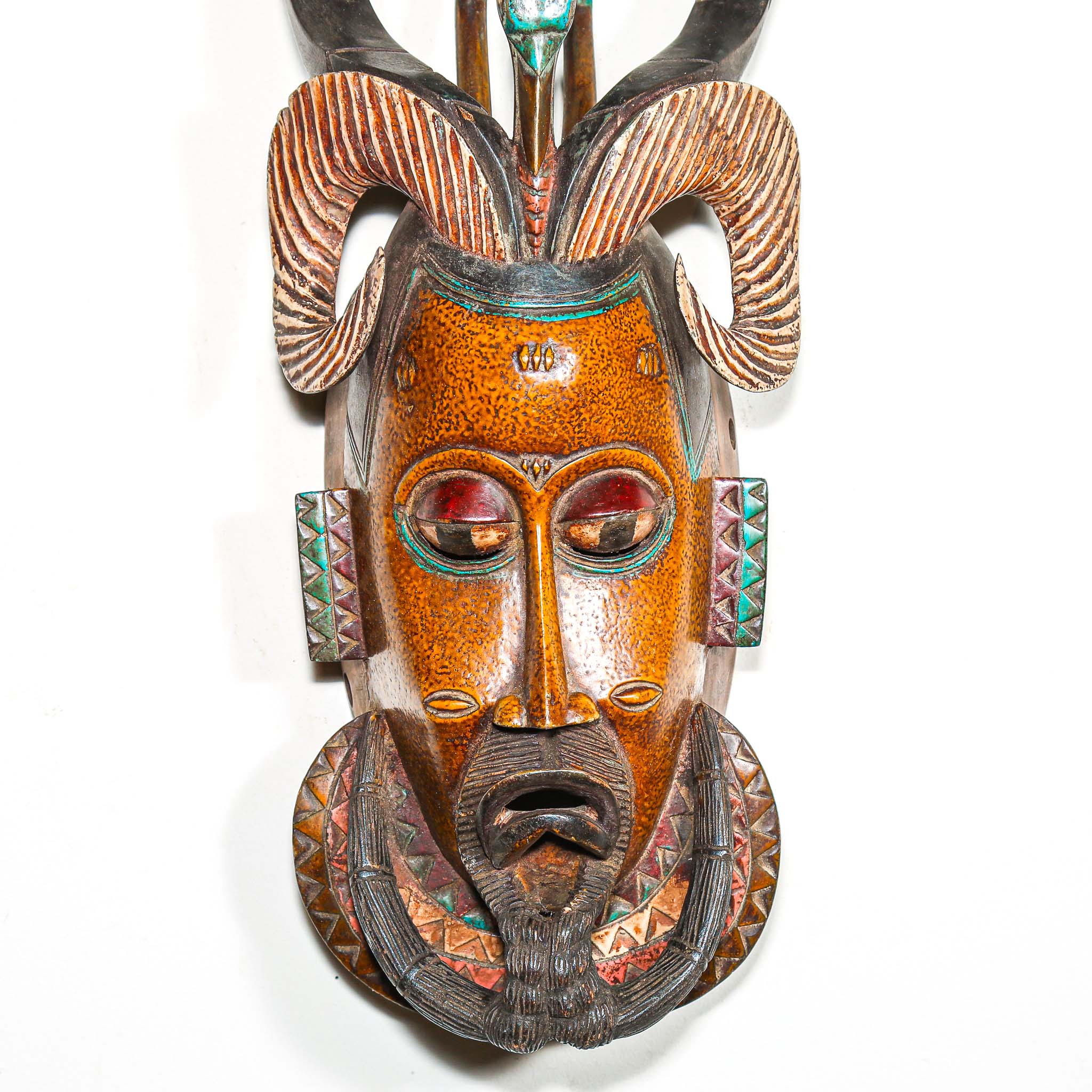Authentic African mask to purchase online with colorful designs on a white background