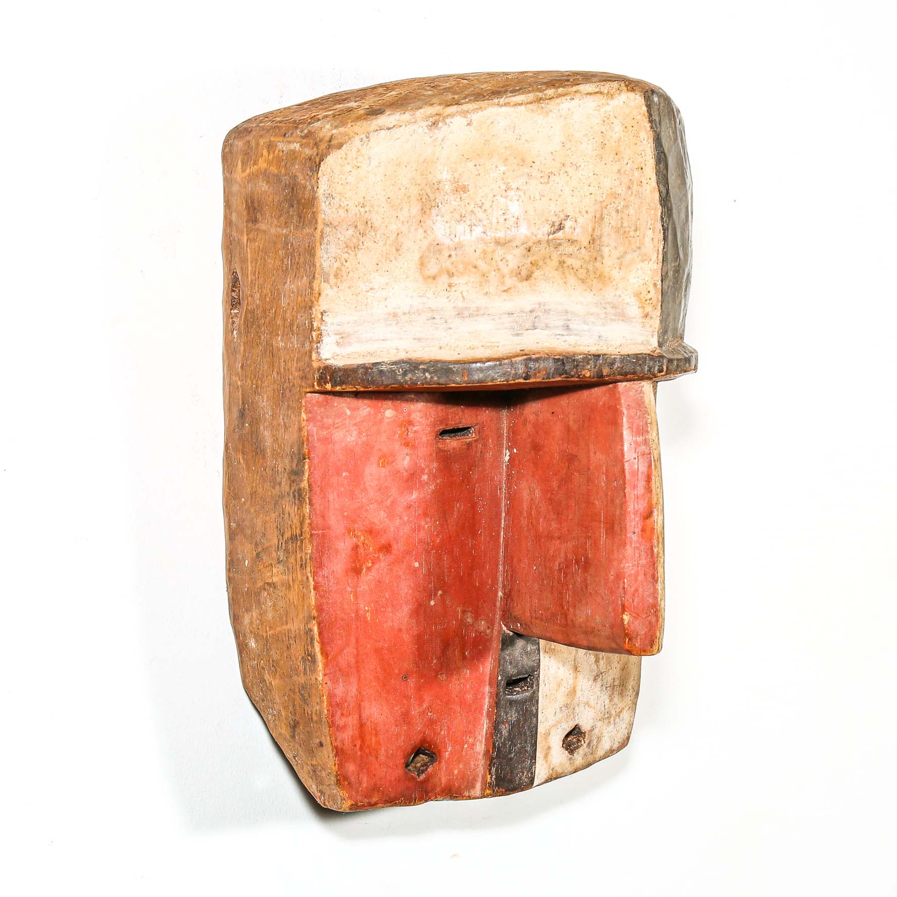 vintage Wooden African mask for sale with a checkered pattern on a white background