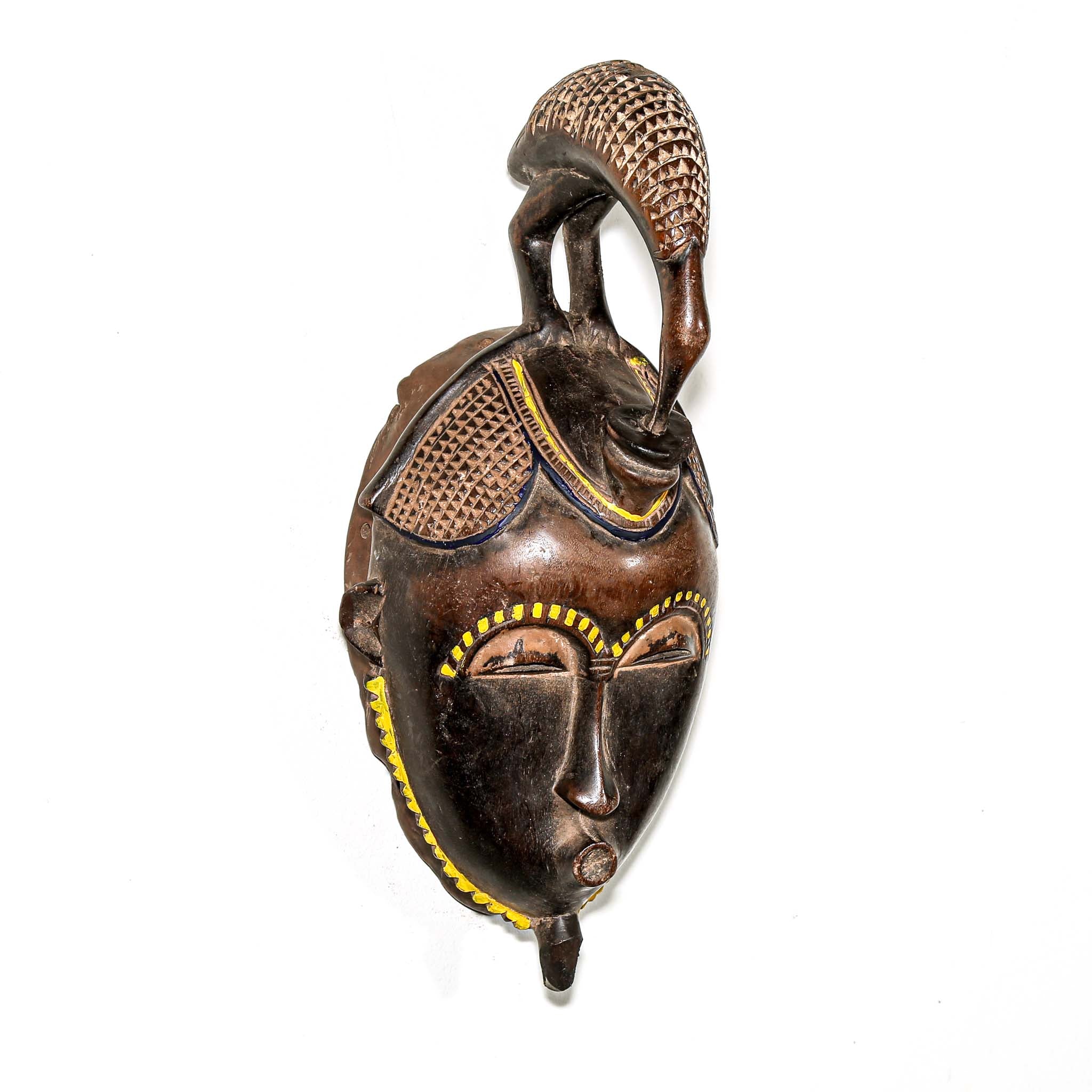 brown ceremonial African mask with intricate yellow painted designs for Sale