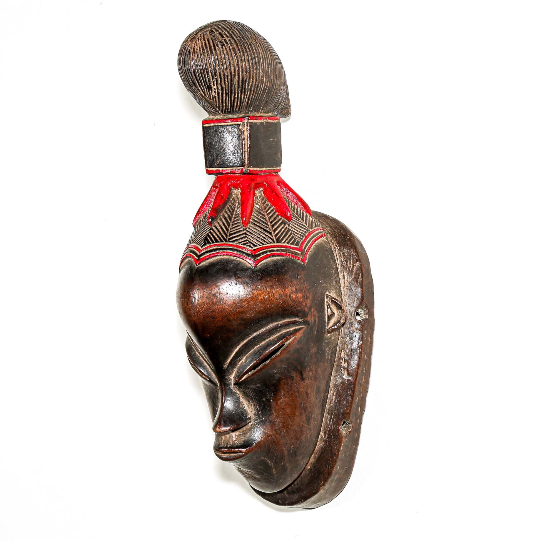 brown ceremonial African mask with intricate red painted designs for Sale