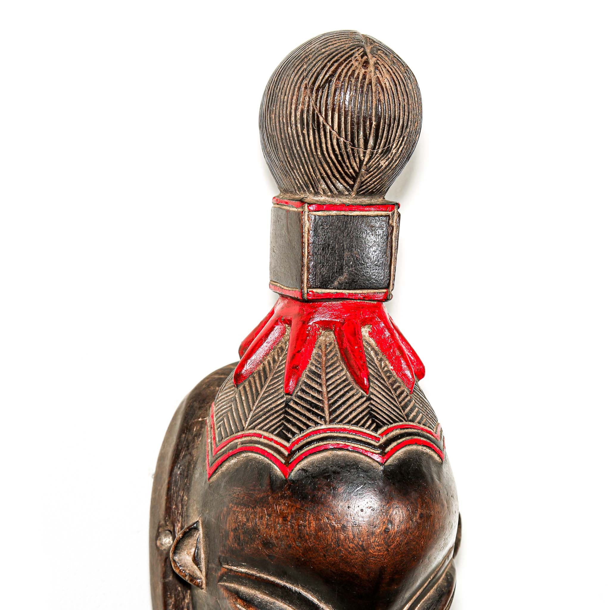 brown ceremonial African mask with intricate red painted designs for Sale